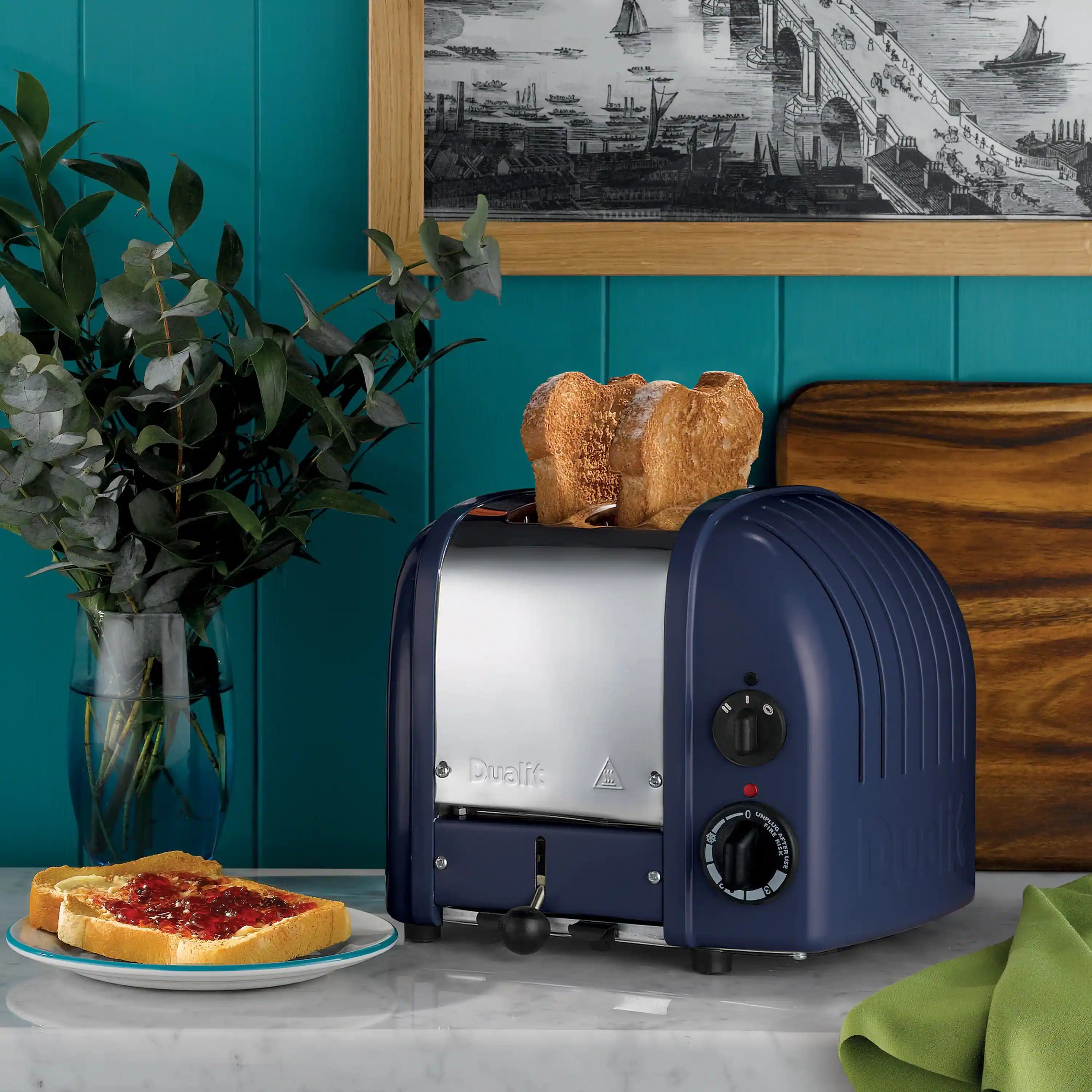 Lavender-blue 2-slice toaster on countertop with control dials and lever