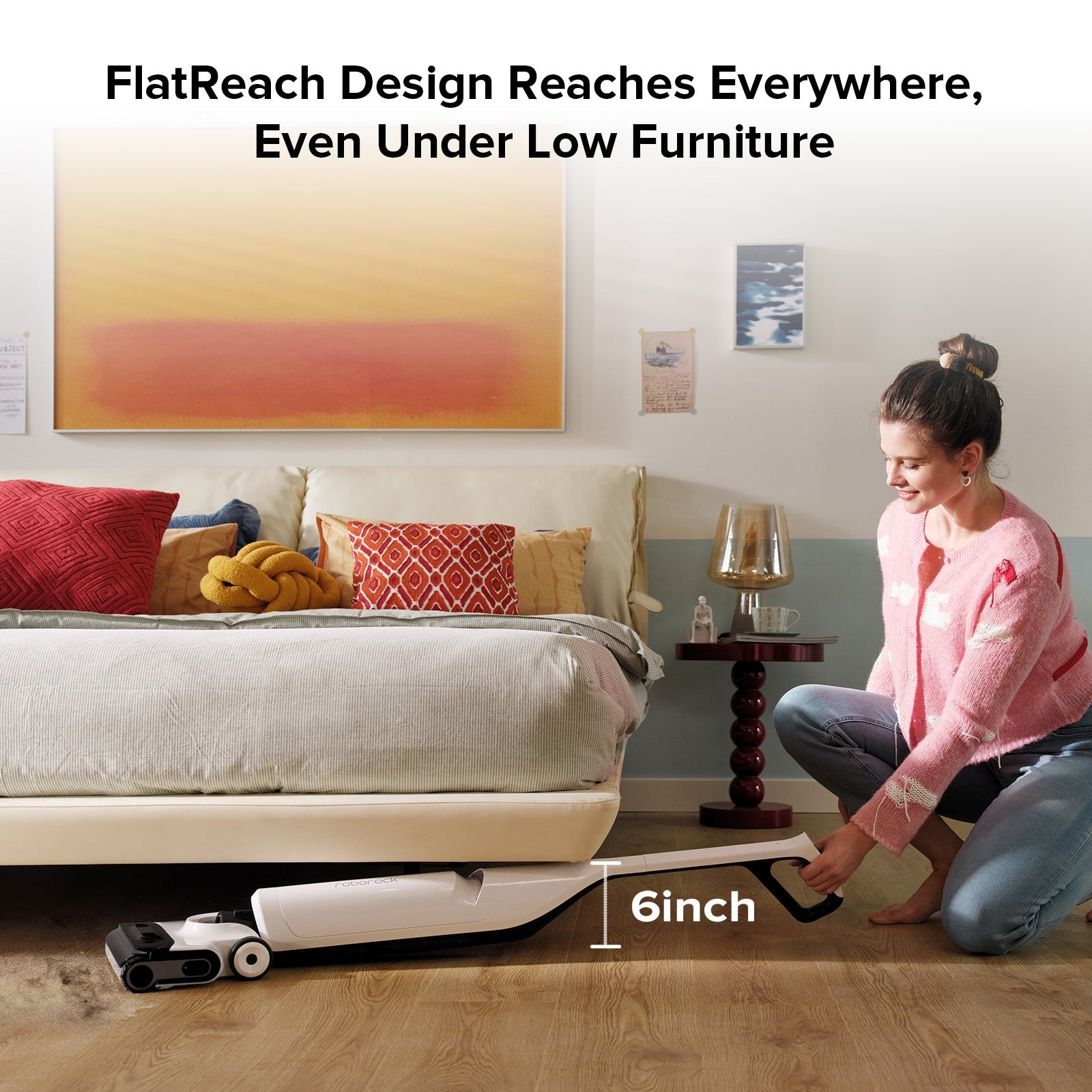 White wet and dry vacuum cleaner reaching under low furniture with flat cleaning head