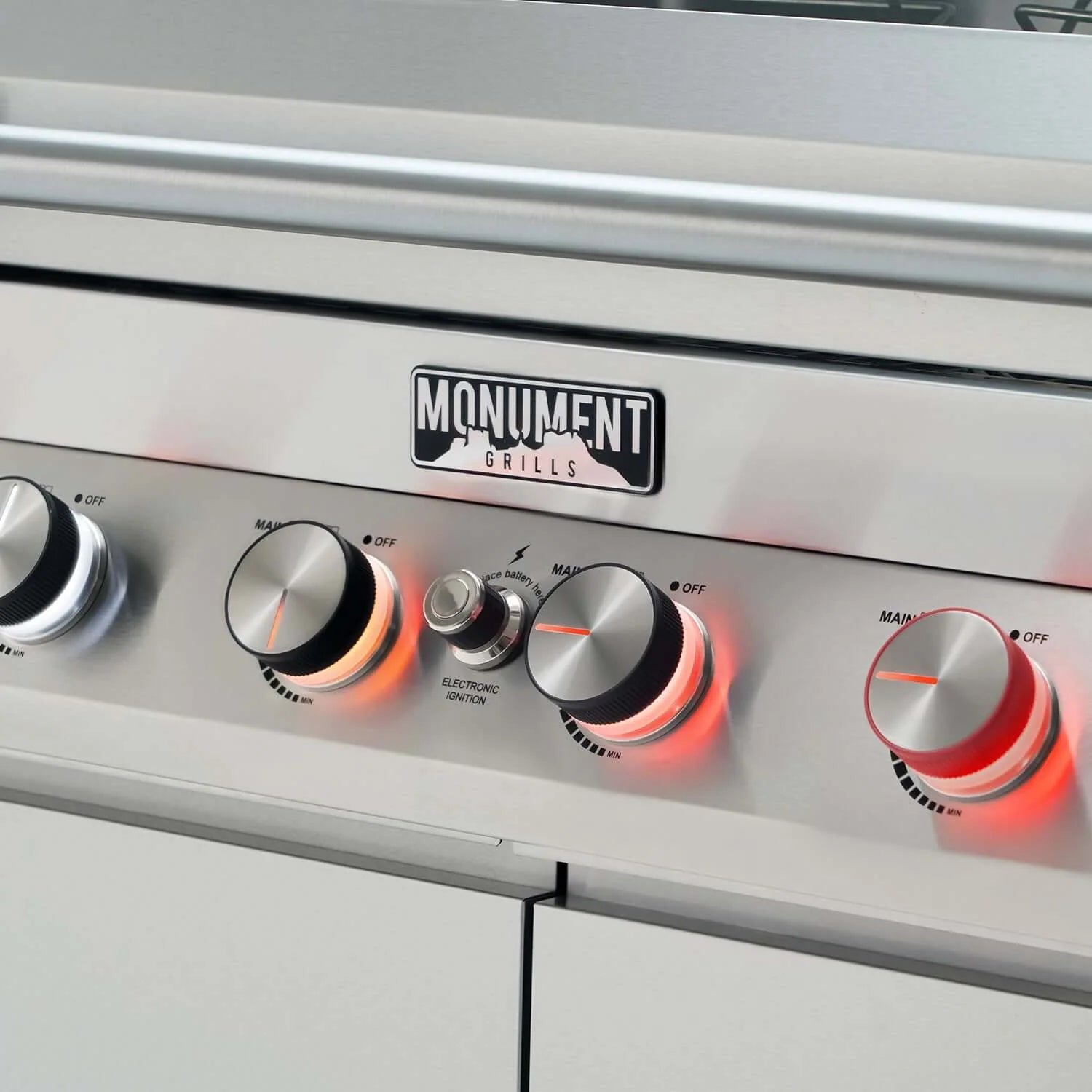 Stainless propane gas grill control panel with multiple round burner knobs and ignition lights