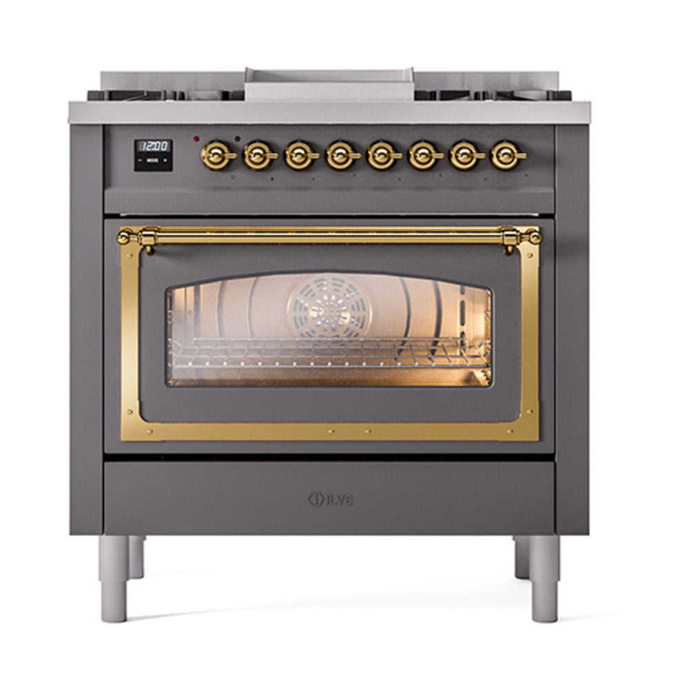Dual fuel range with matte graphite body, brass knobs, and lit triple glass door