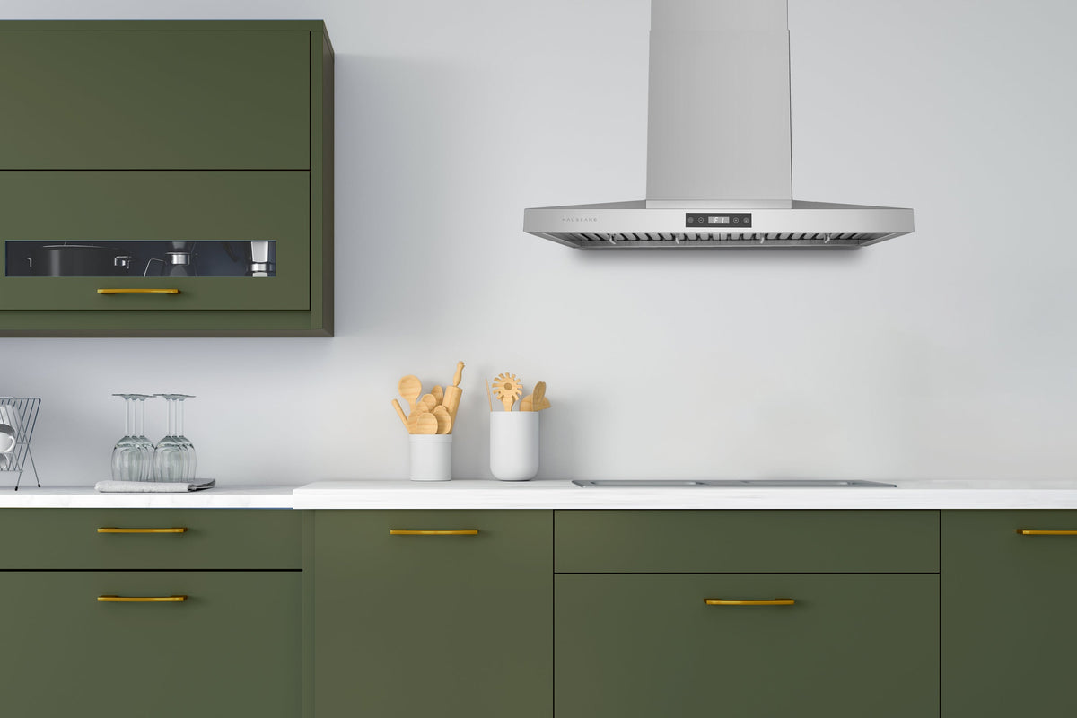 Stainless steel wall mount range hood above cooktop with rectangular chimney