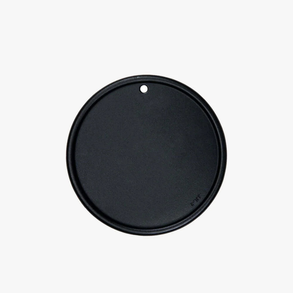 Round cast iron cooking plate with black finish and small top vent hole
