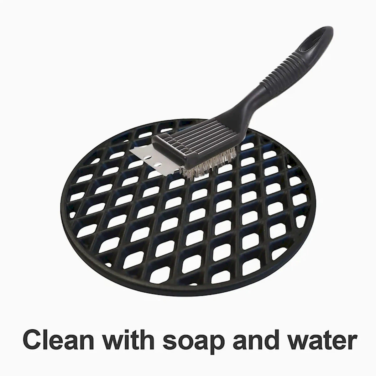 Black round cast iron grill grate with diamond grid and cleaning brush handle