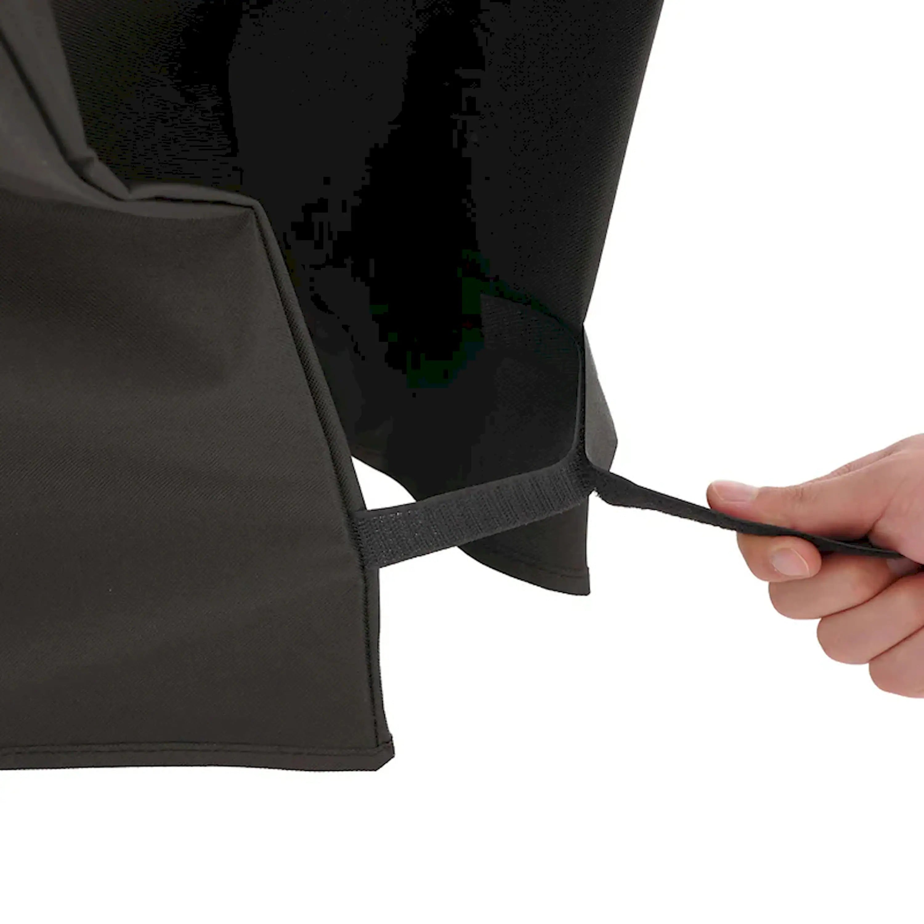 Black grill cover corner with adjustable strap and visible seam detail