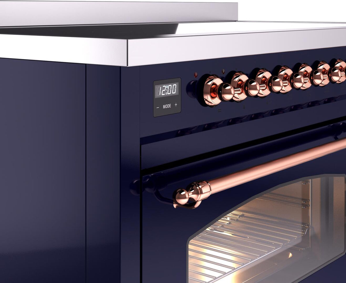 Midnight blue range control panel with copper knobs and lit oven door
