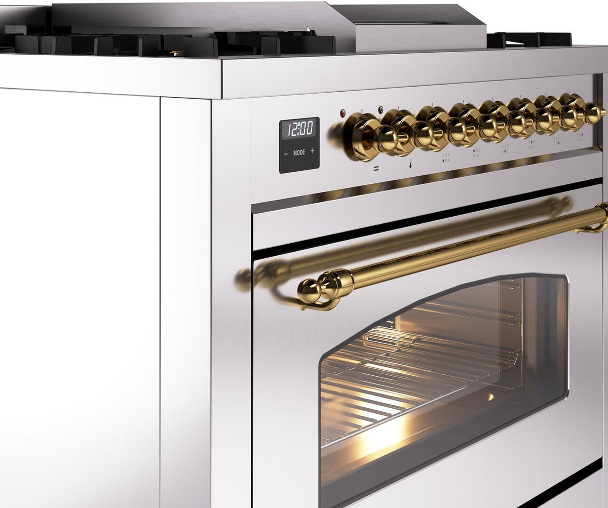 Range control panel with brass burner knobs and long brass oven handle