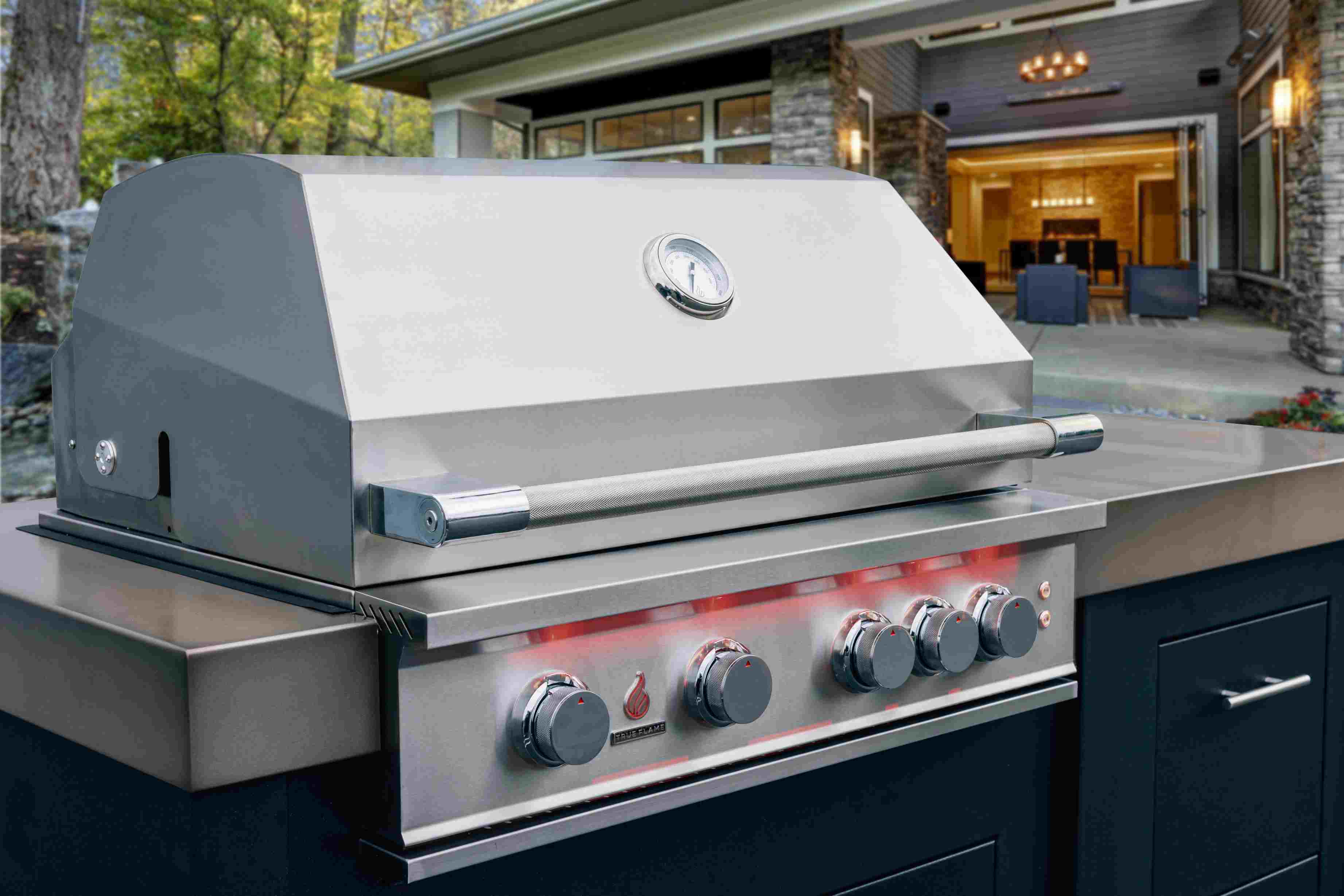 Stainless steel built-in natural gas grill with side burner and control knobs