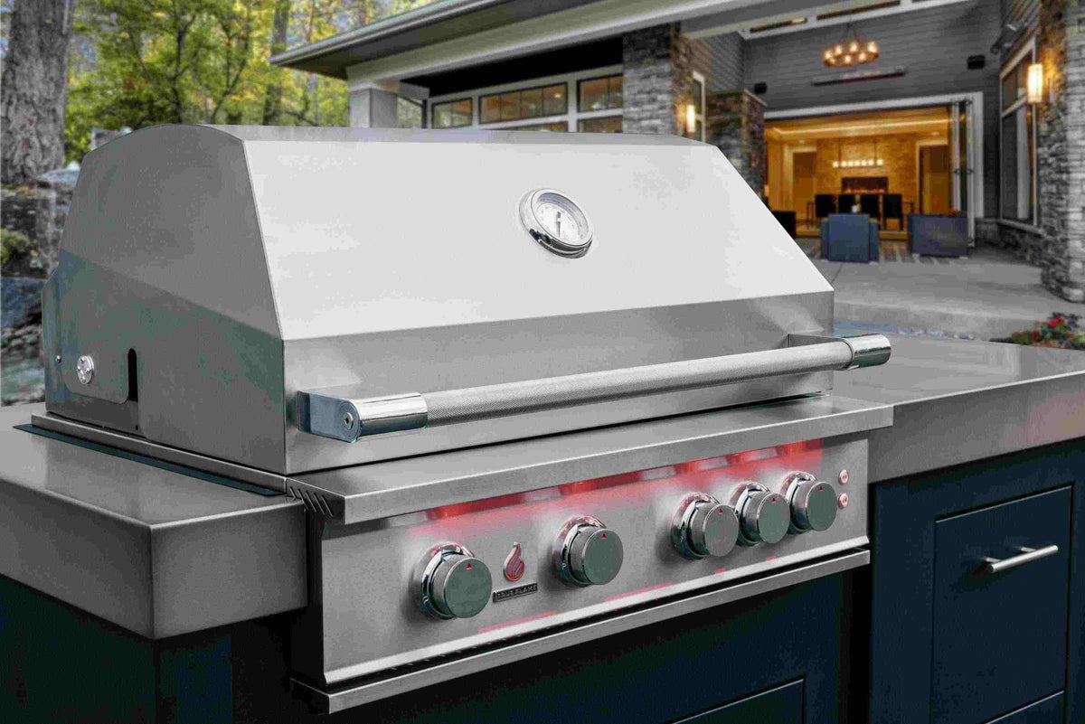 Stainless steel built-in propane gas grill with closed lid and control knobs