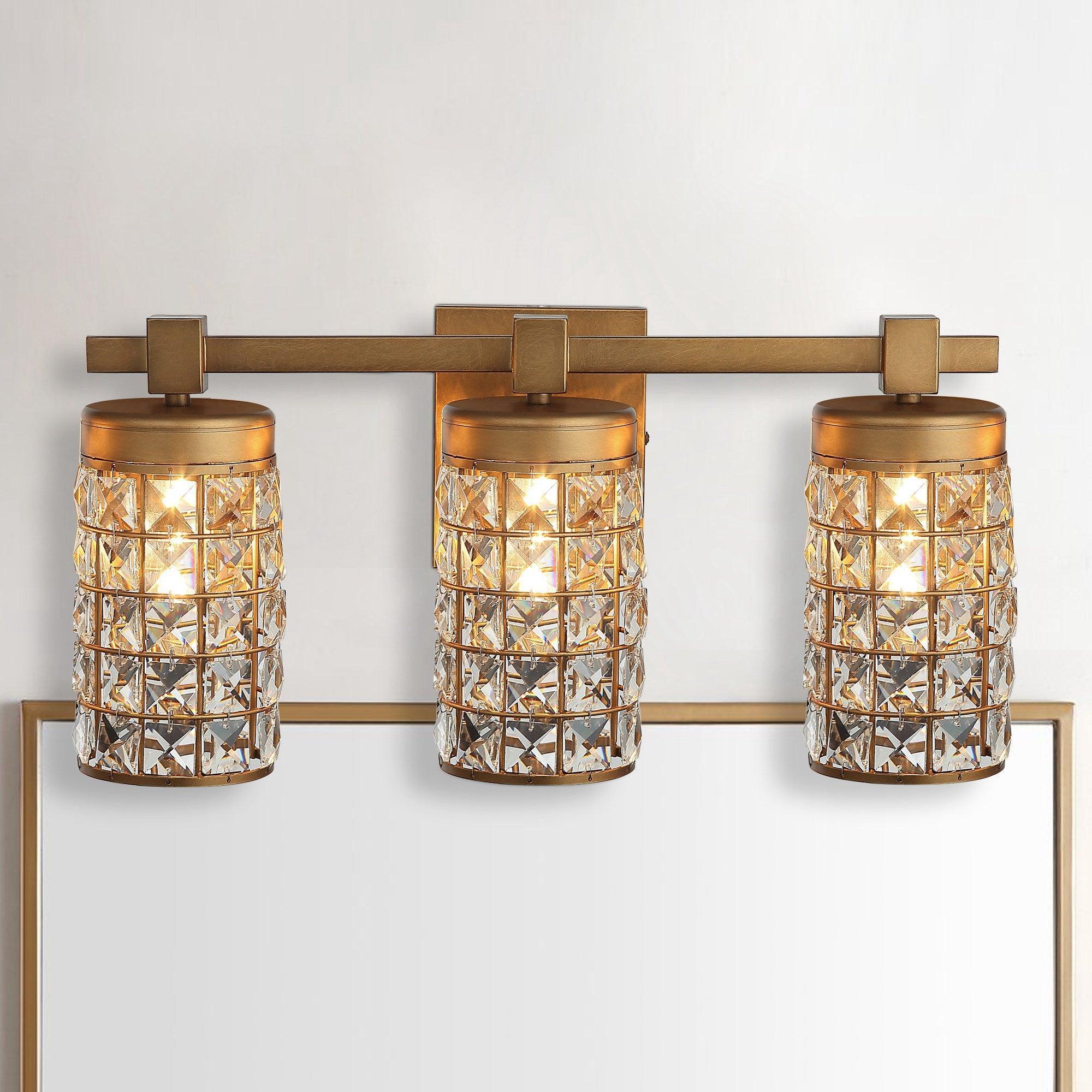 Golden 3-light vanity wall sconce with linear bar and three crystal glass cylinder shades