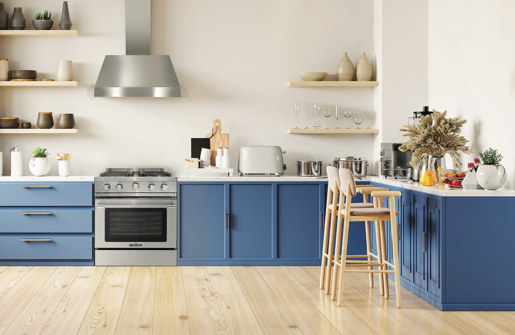 Stainless gas range with multiple burners in modern kitchen with blue cabinets