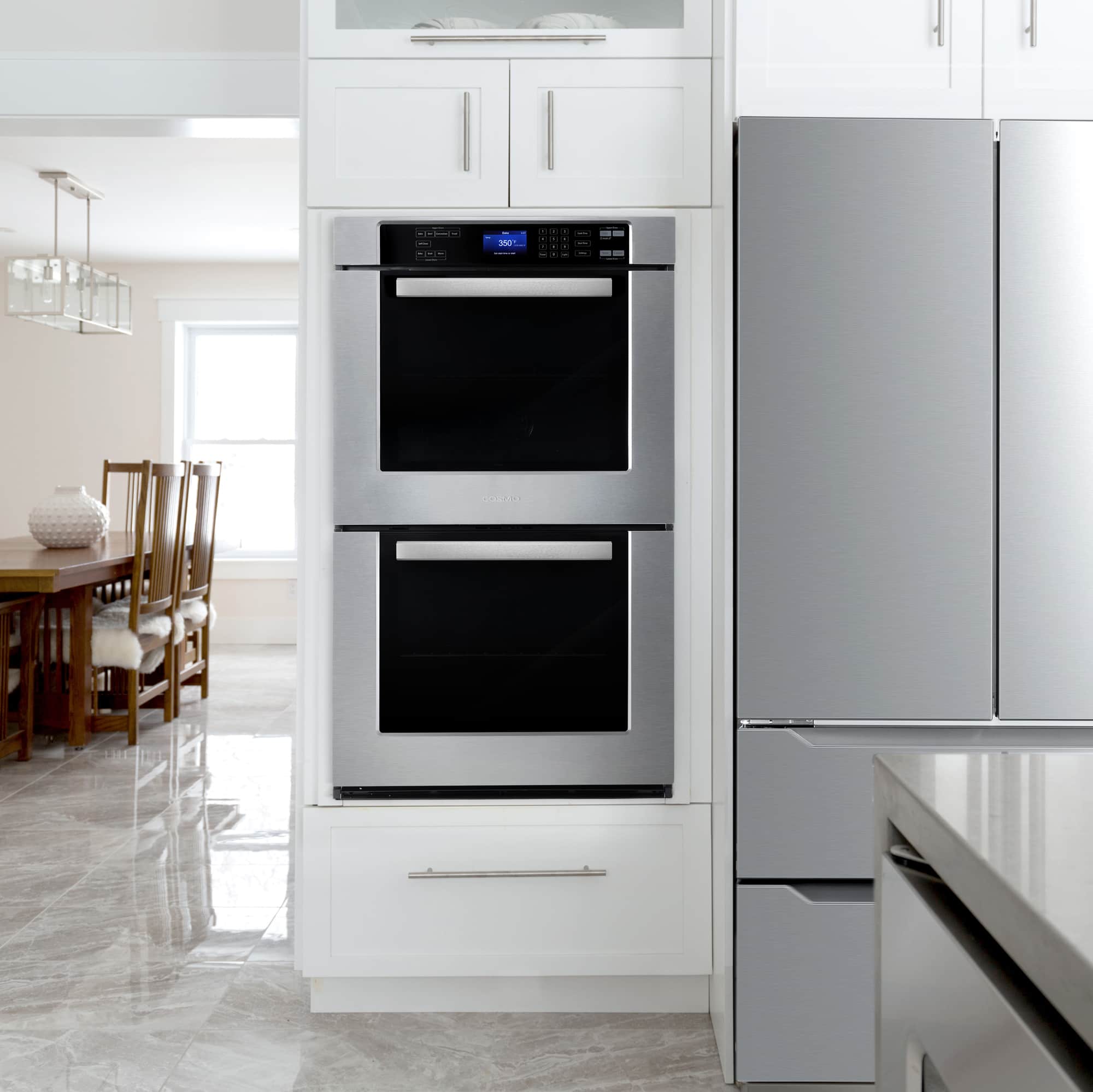 Built-in stainless double wall oven installed in a kitchen with both doors closed