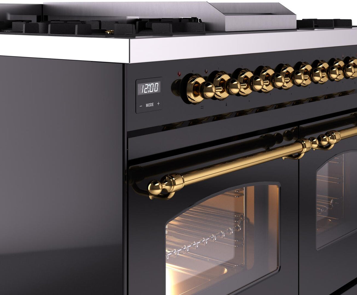 Dual fuel range close-up of brass control knobs and gold oven handle on black body.