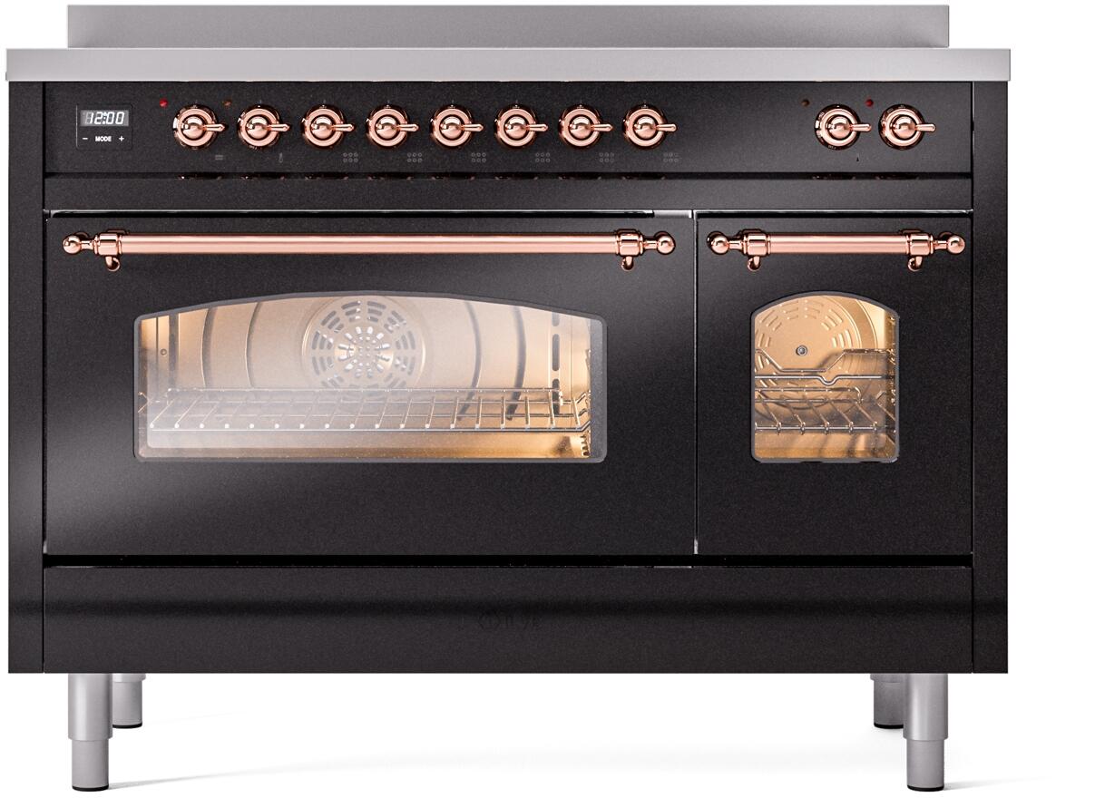 Freestanding induction range with glossy black doors, copper trim knobs, and viewing window