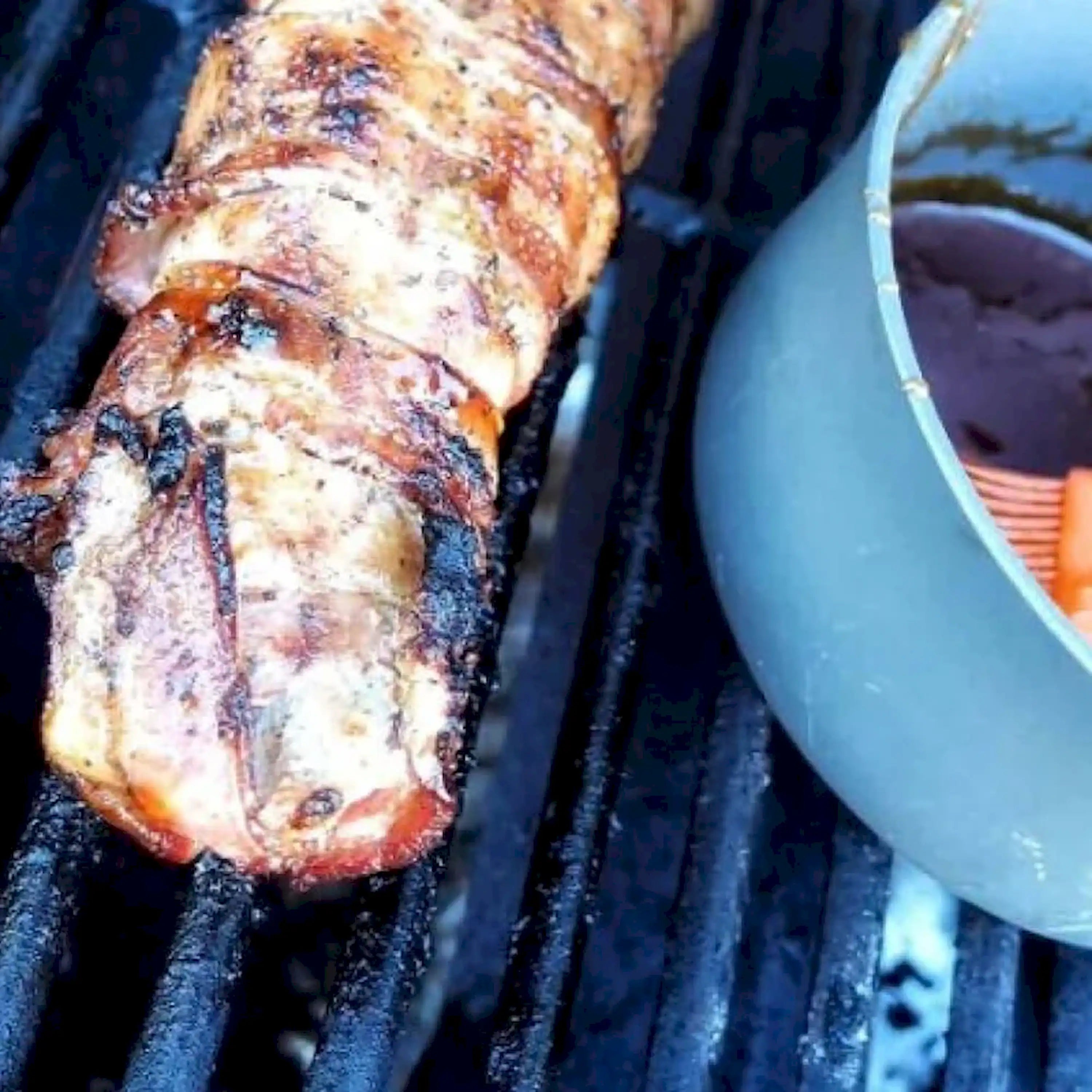 Roasted chicken on grill grate with browned skin and visible grill marks