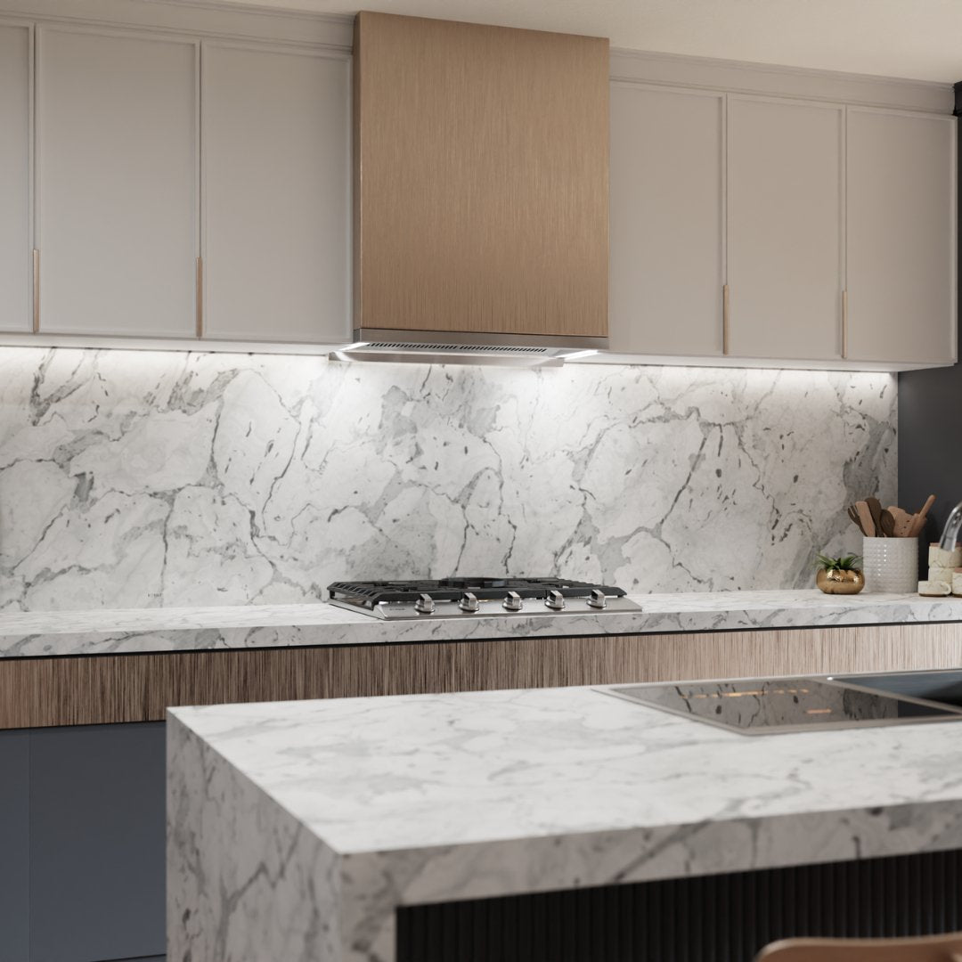 Stainless under-cabinet insert range hood over a cooktop beneath upper cabinets