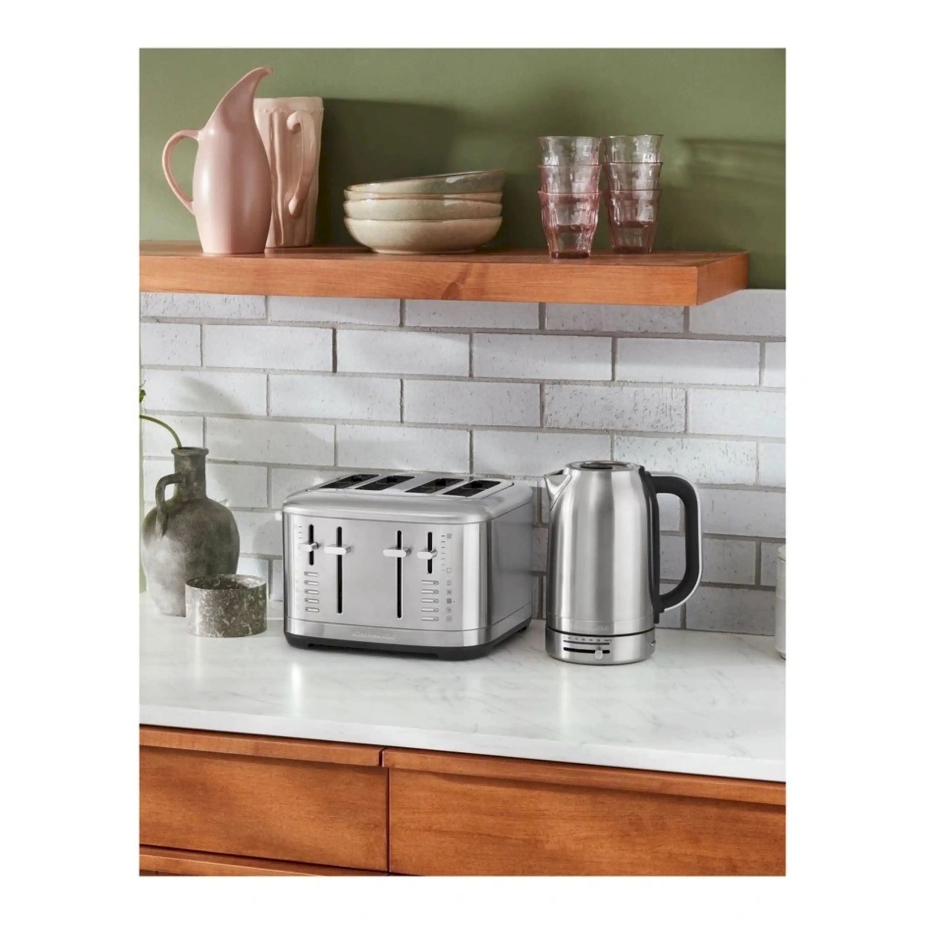 Brushed stainless steel 2-slice toaster on countertop, with two bread slots and controls