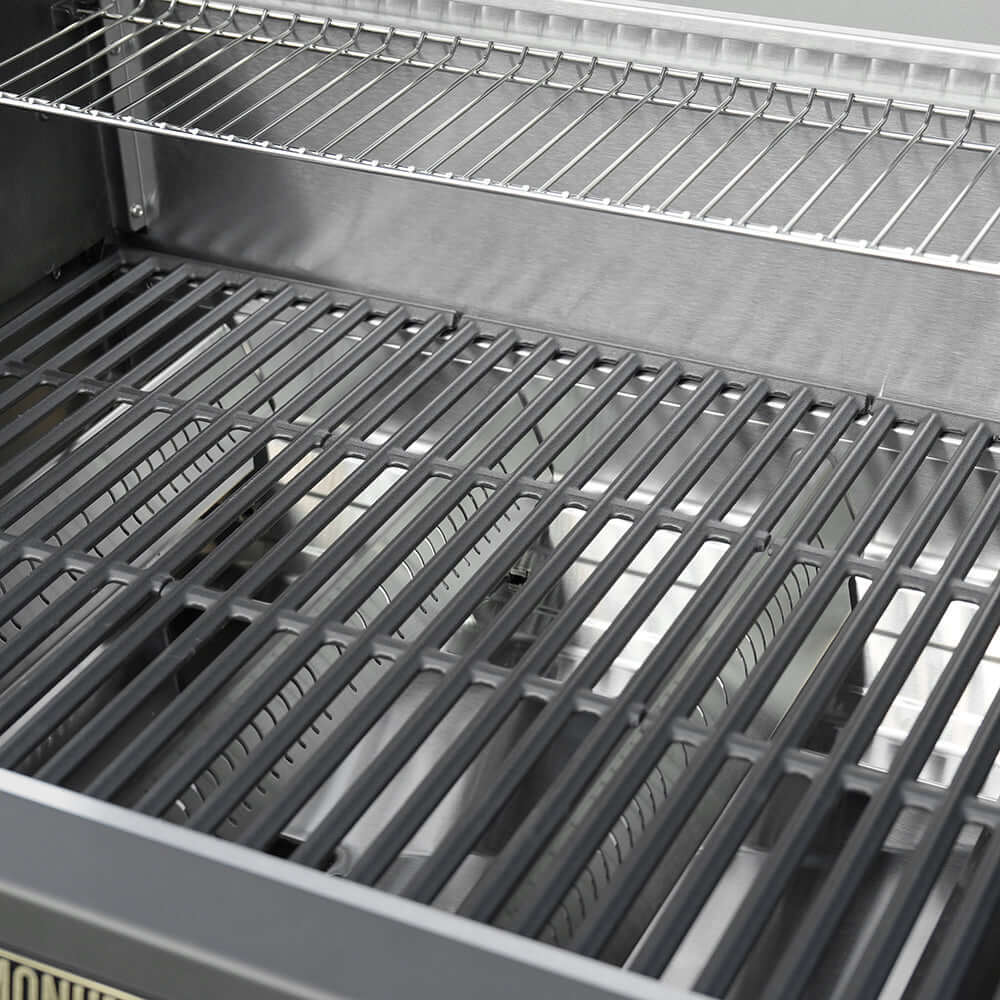 Interior of propane gas grill showing cast-iron cooking grates over burners