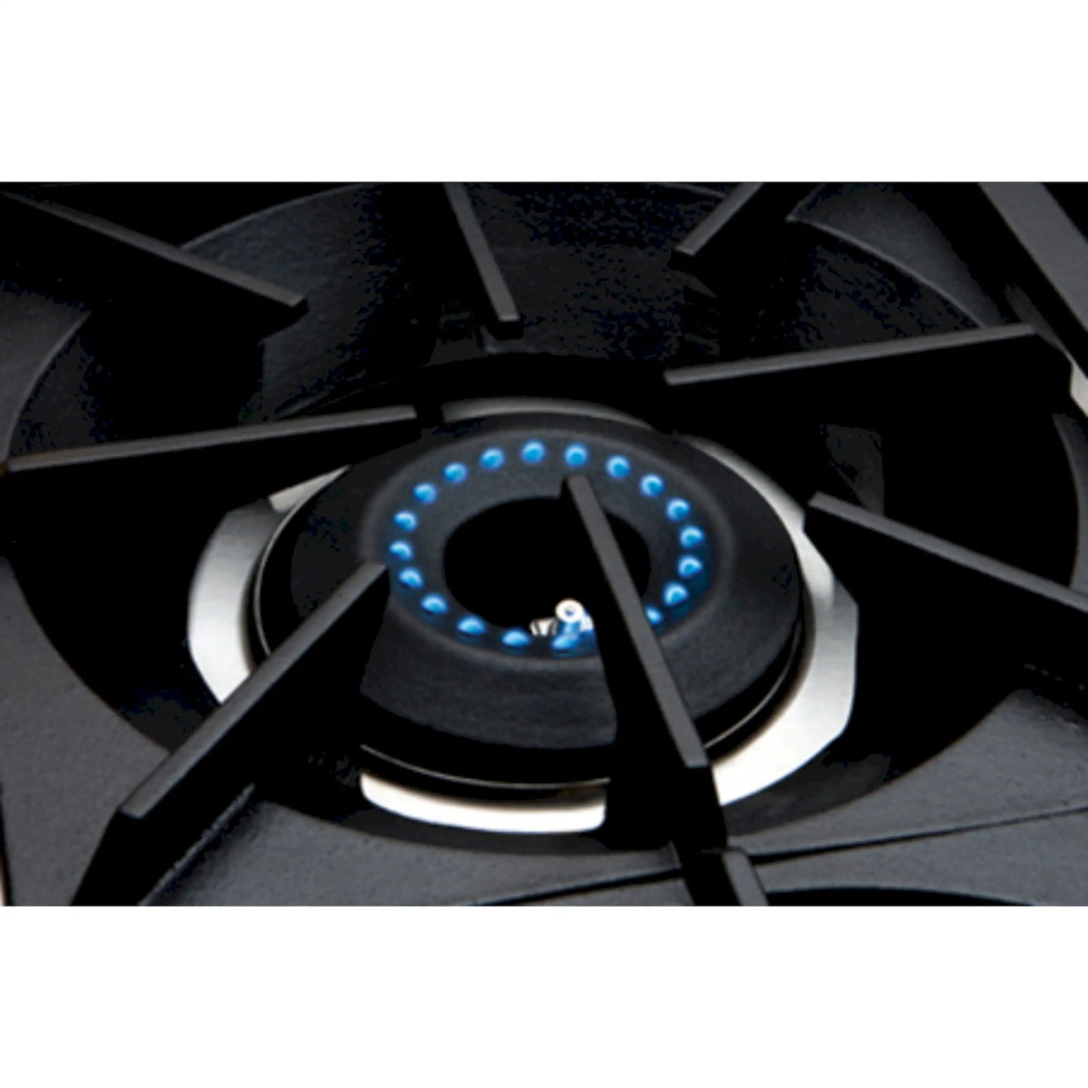 Close-up of gas burner ring with blue ignition flames on the cast-iron grate