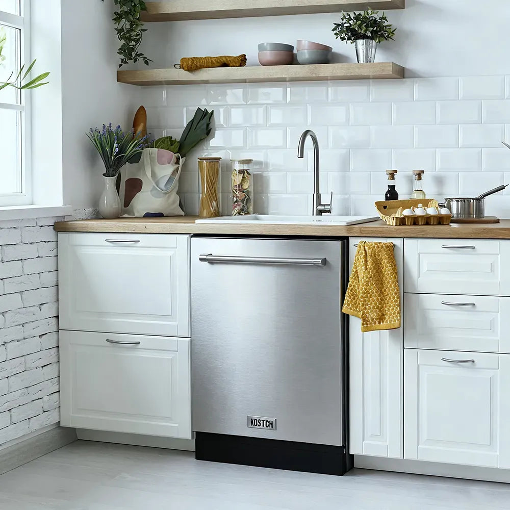 Stainless steel built-in dishwasher installed in a white kitchen with cabinetry