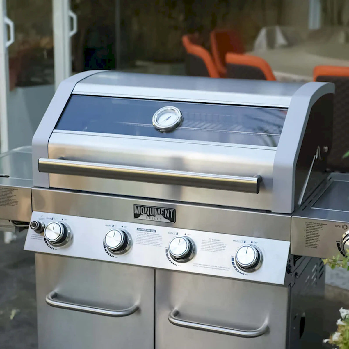 Stainless steel infrared gas grill front with burner knobs and closed lid