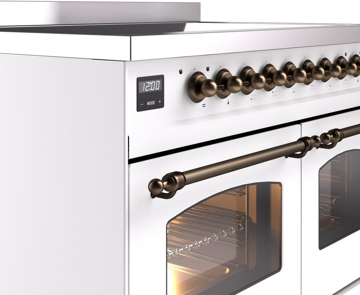 White induction range control panel with bronze knobs and oven door with window