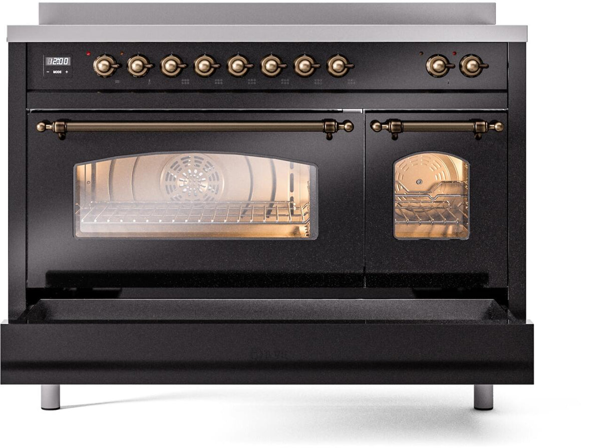 Freestanding induction range with oven window illuminated and lower handle in bronze finish