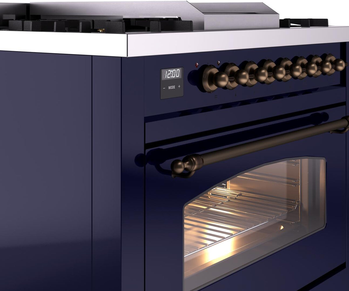Midnight blue oven control area with bronze knobs and oven door window