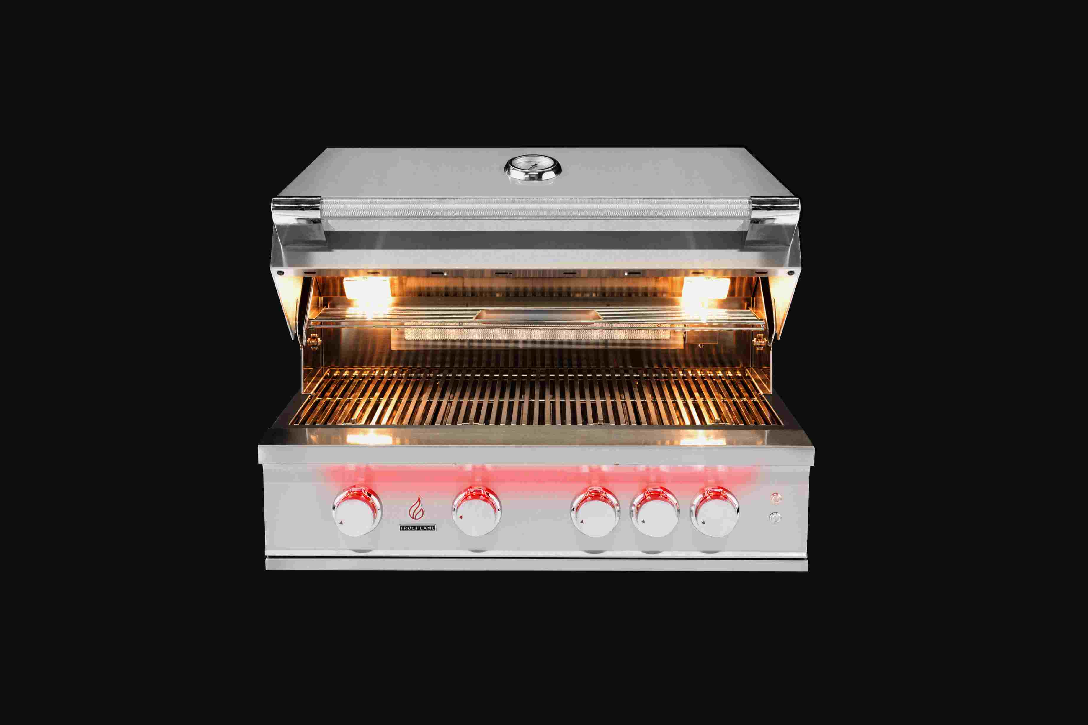 Stainless steel gas grill with lid open, burner flames and front control panel
