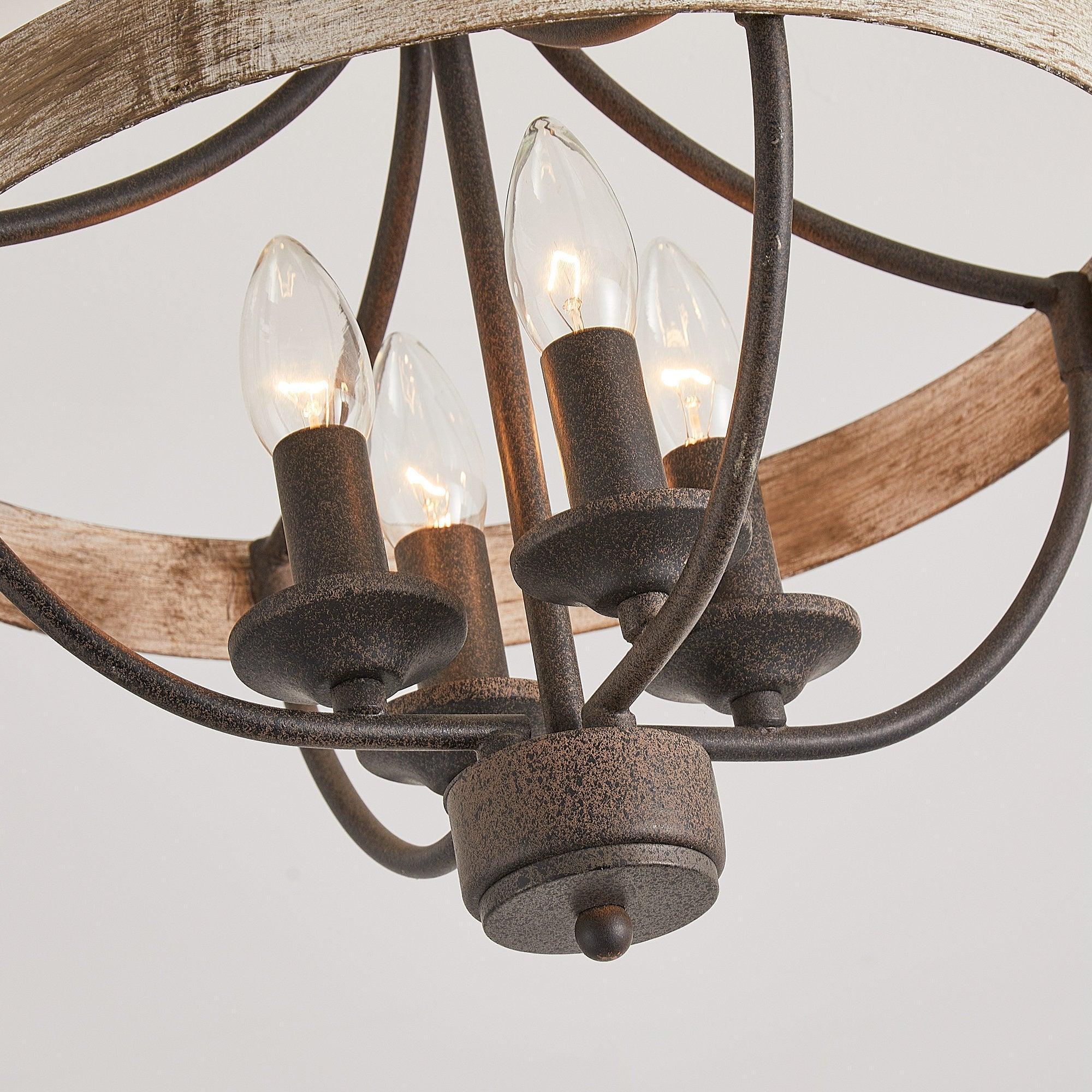 Detail of 4 lit bulbs in black metal cage under brown wood-look ceiling ring