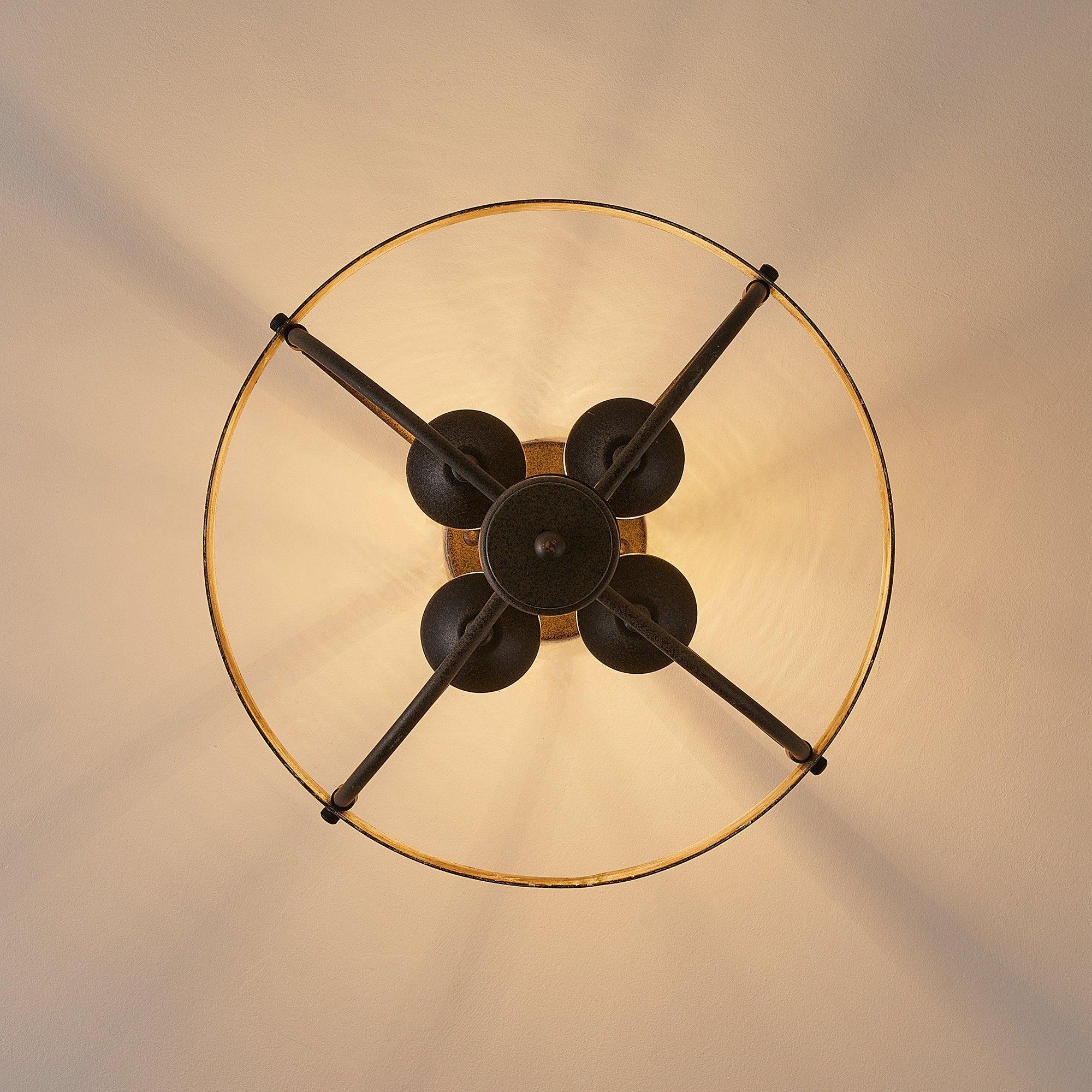 Black ceiling fan with five blades and a round center light