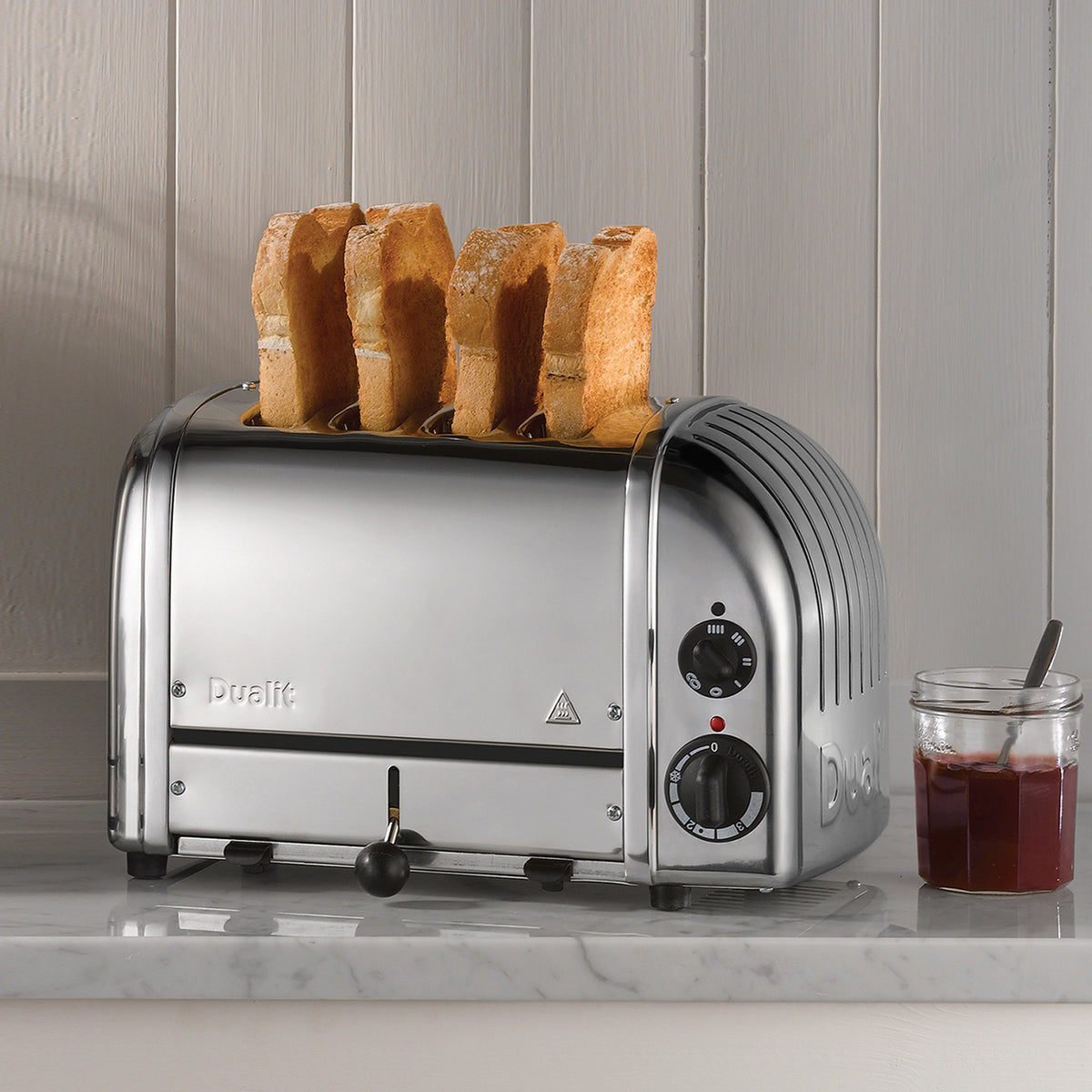 Dualit 4-slice chrome toaster showing upright bread in the slots