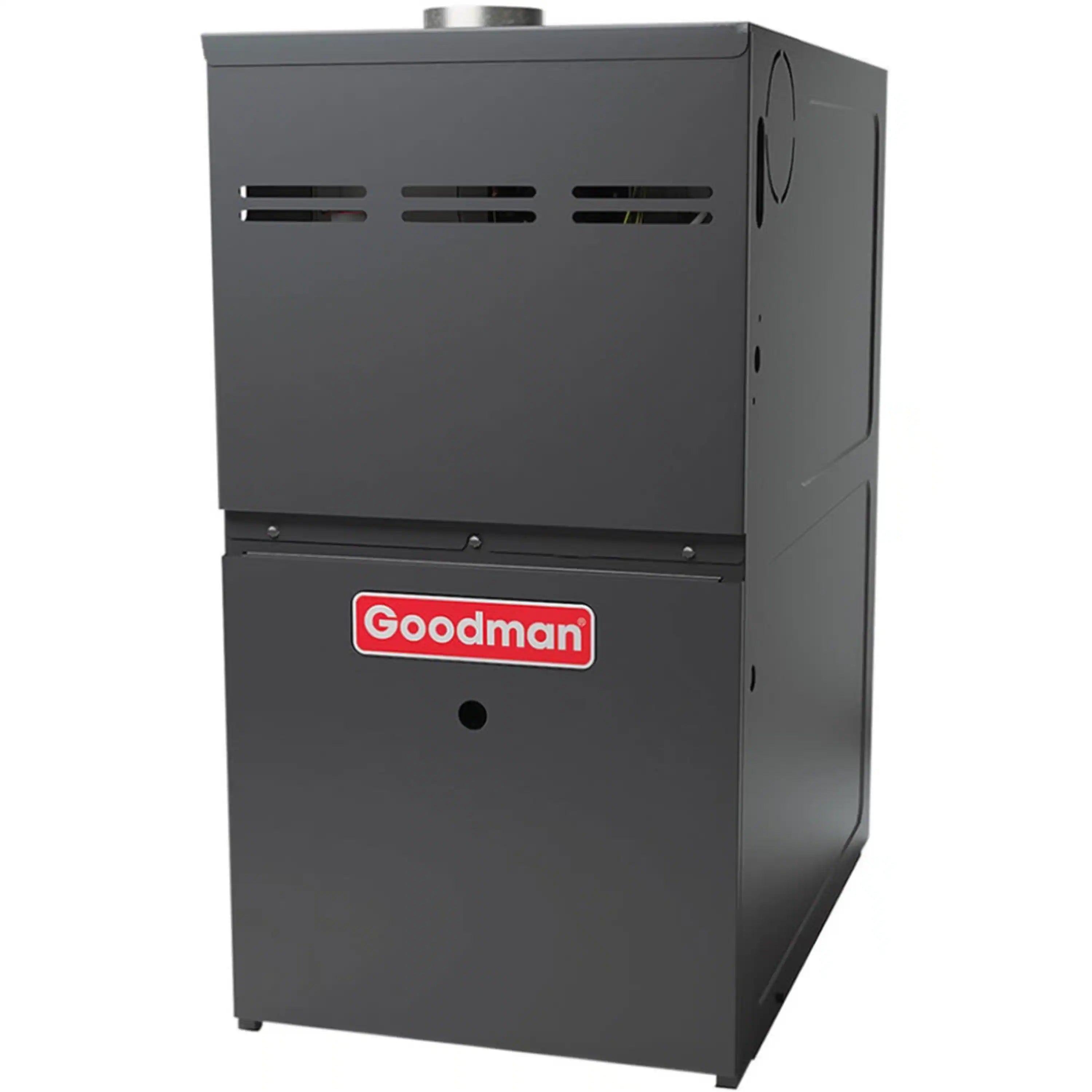 Goodman dark gray gas furnace with louvered top vents and front badge.