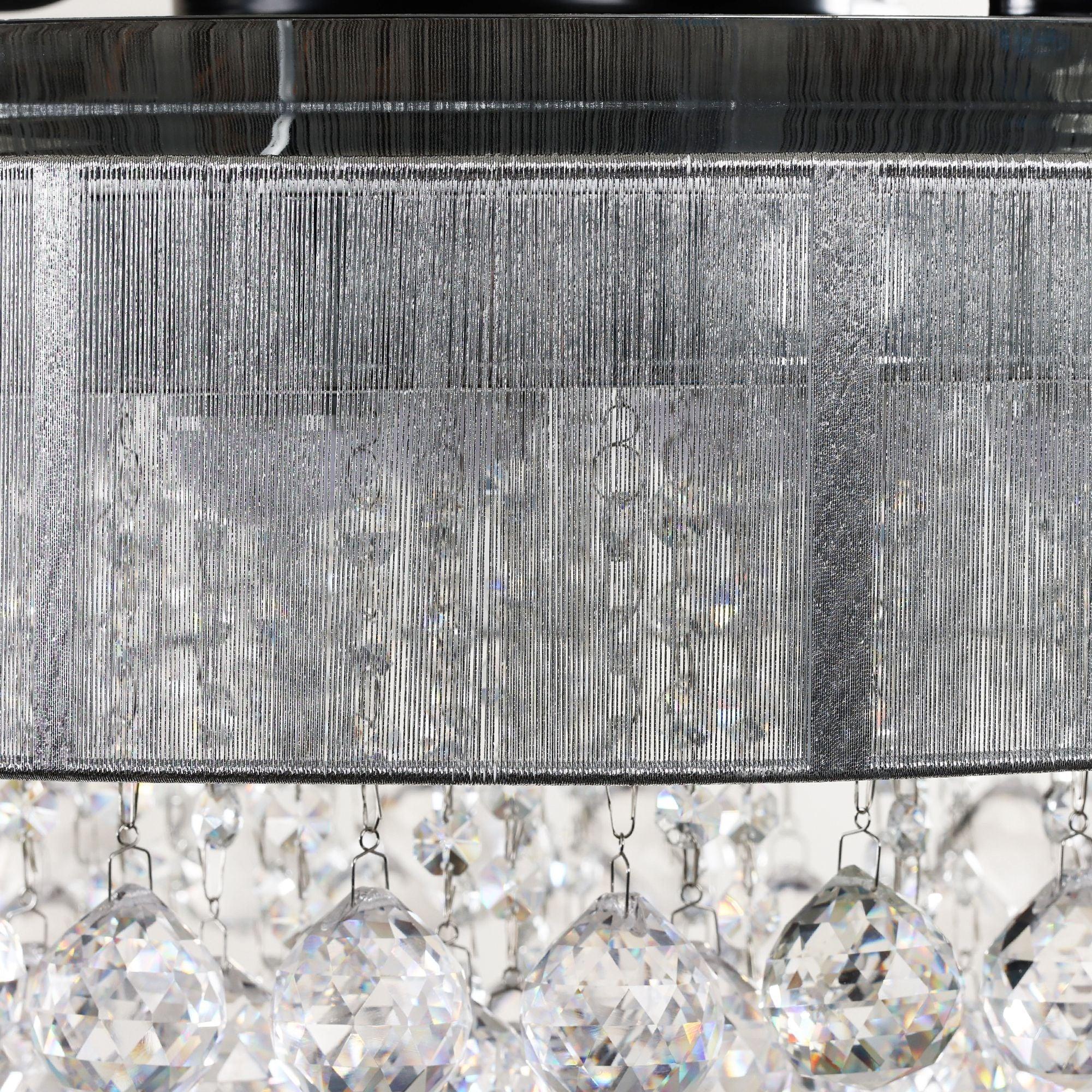 Close-up of crystal-style LED light strands under a chrome ceiling fan cover