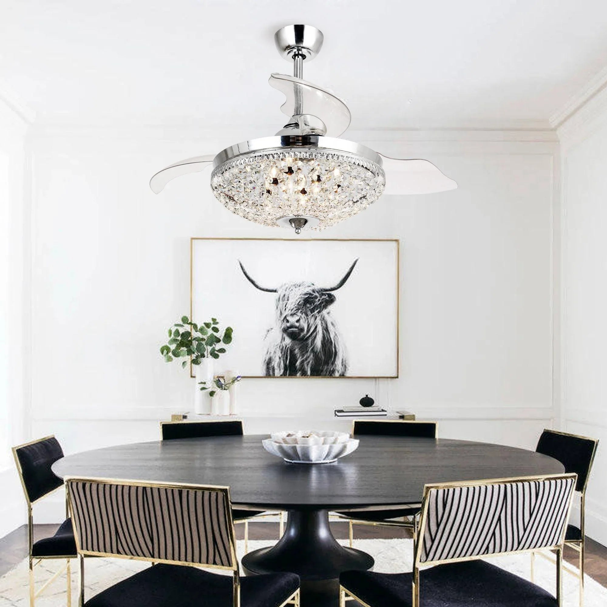 Chrome crystal ceiling fan with round light and retractable clear blades in room