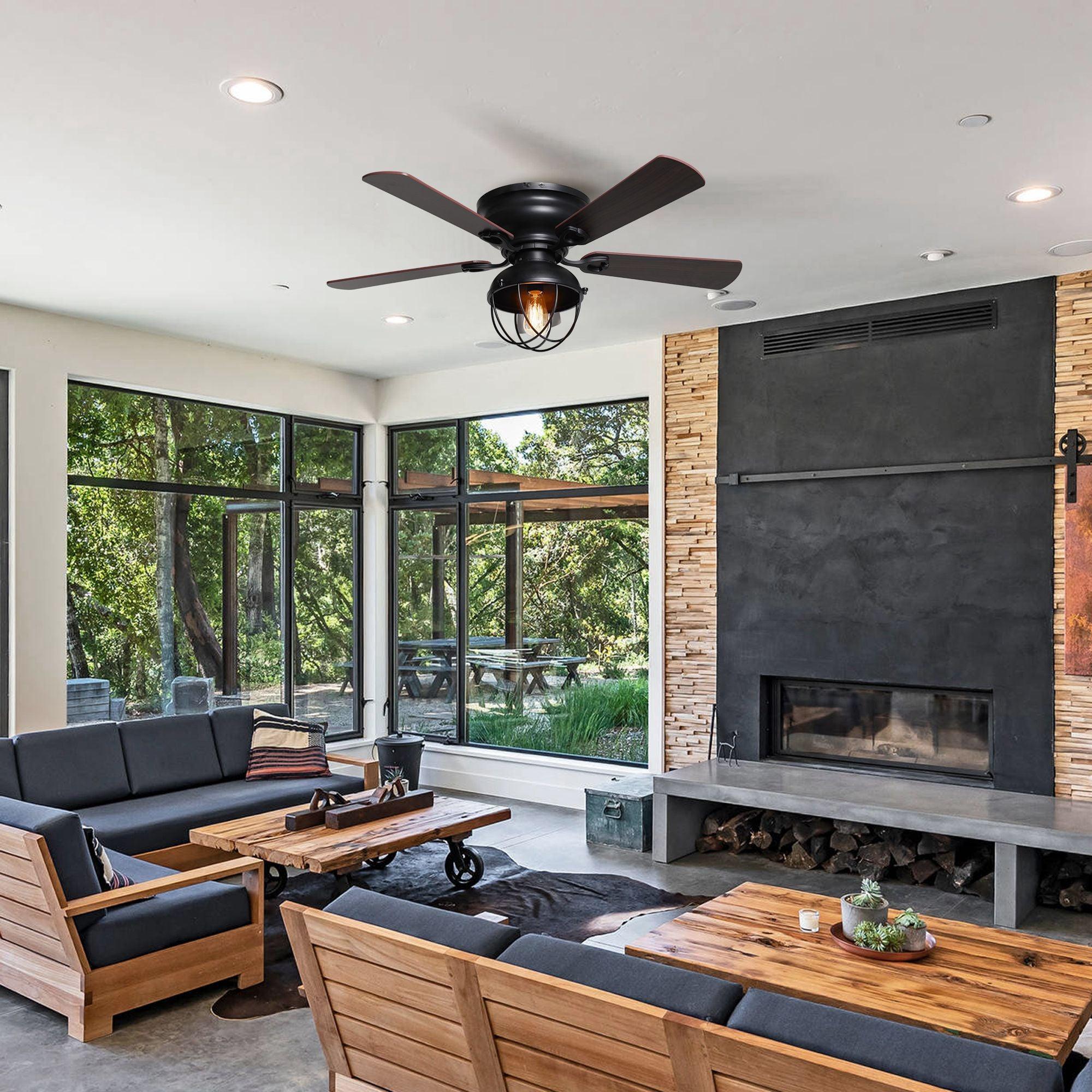 Black ceiling fan with dark wood reversible blades and glowing lantern light