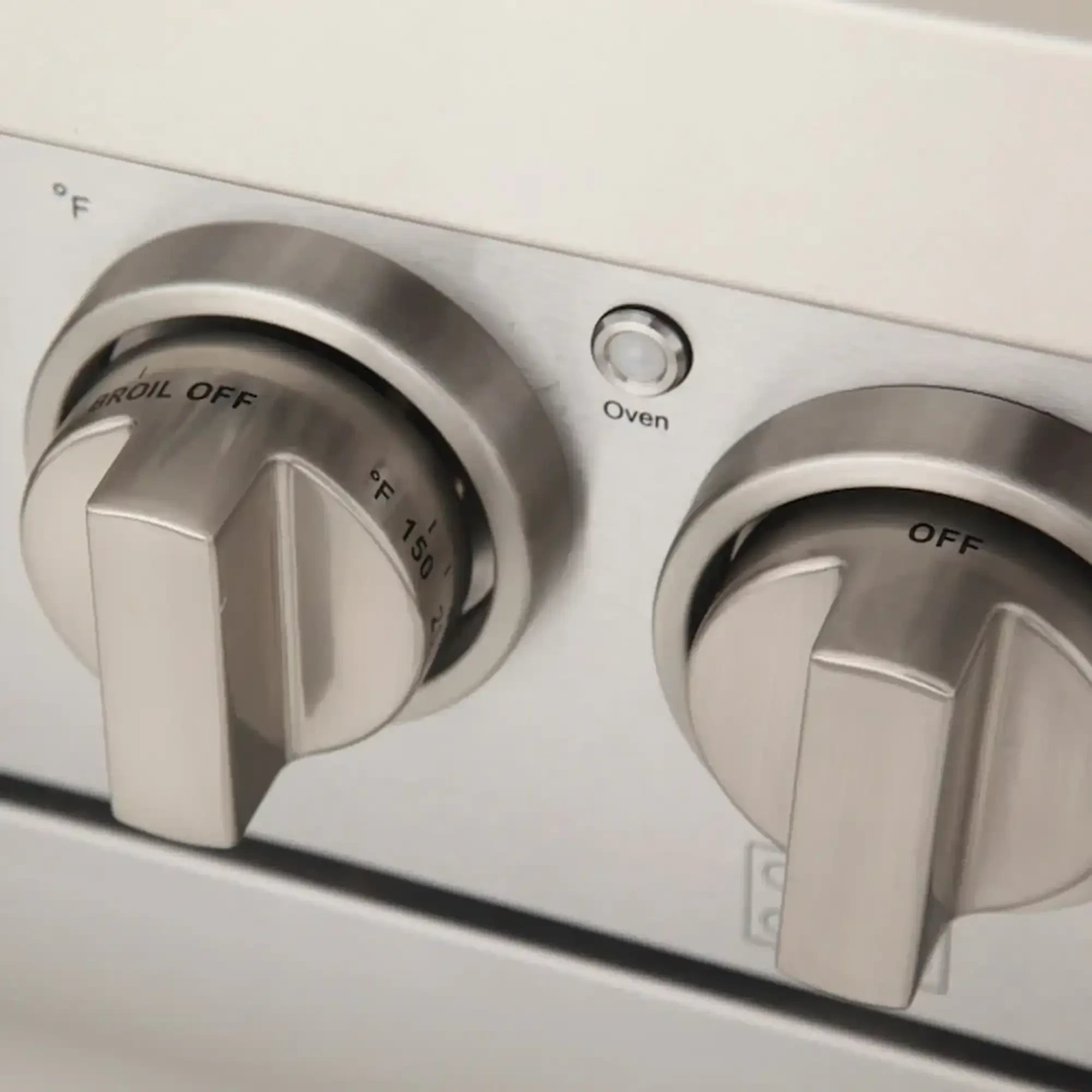 Olive green gas range with silver burner and oven control knobs, labeled OFF and F