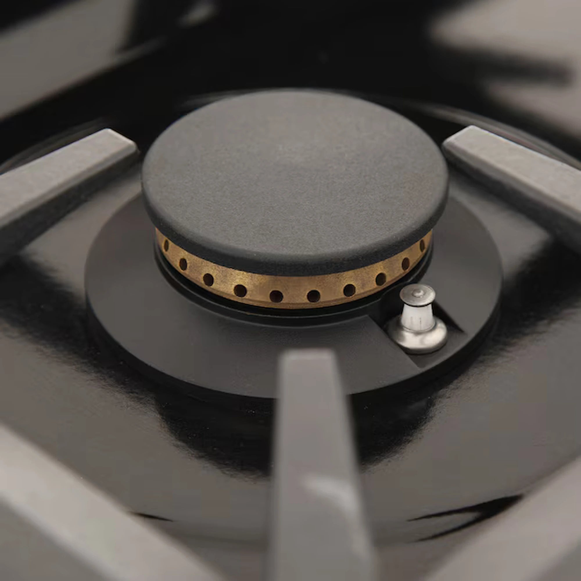 Gas range sealed cooktop burner with round metal cap and control knob on side