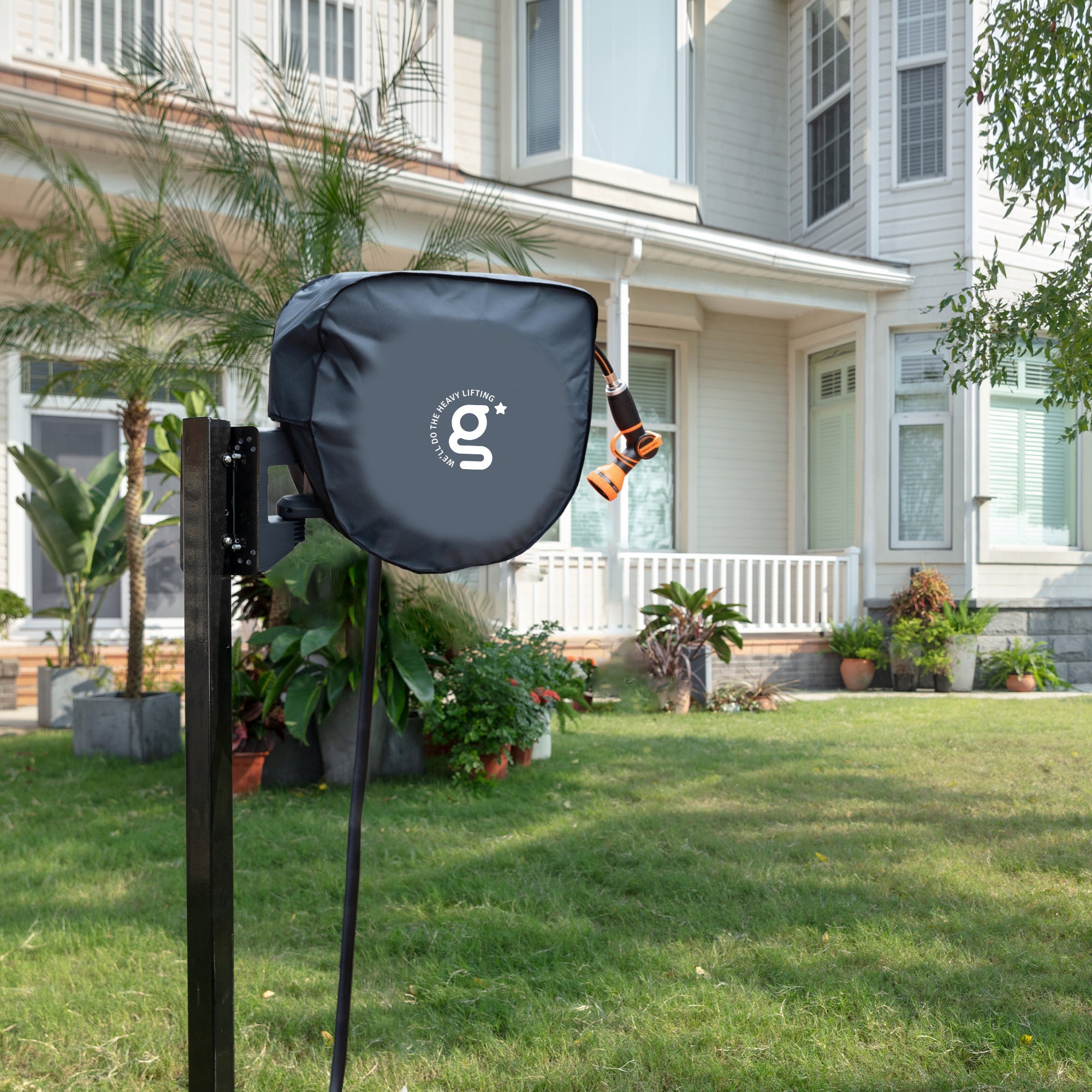Dark gray hose reel cover on outdoor post with g-logo front