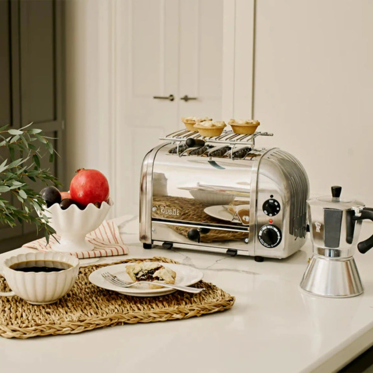 Countertop toaster oven with stainless warming rack and pastries