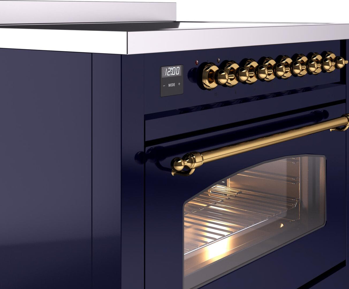 Brass control knobs and oven handle on midnight blue electric induction range with door window