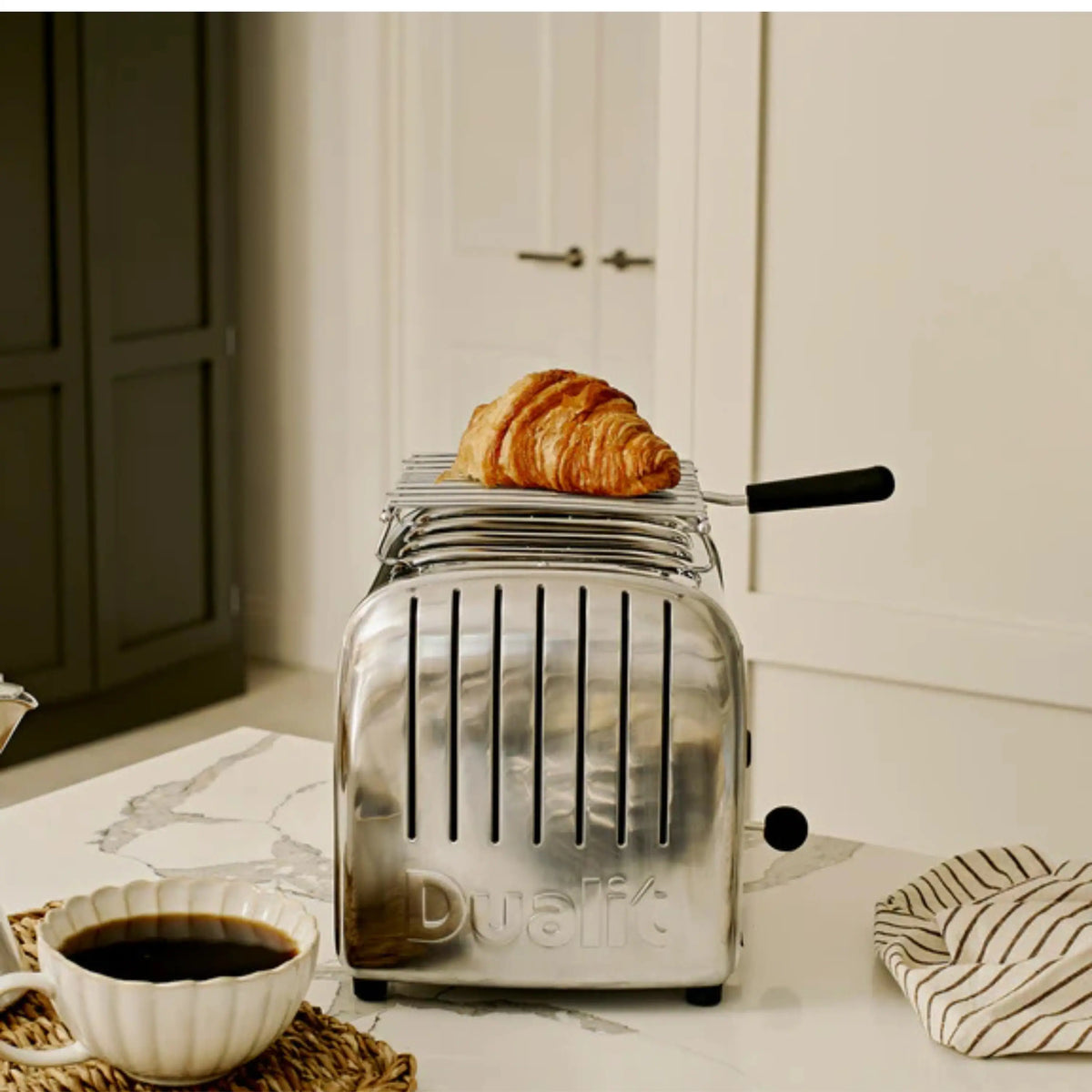 Glass-front toaster with pastry on wire warming rack