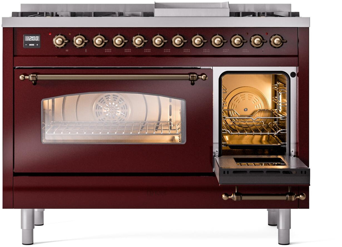 Freestanding dual fuel range with left oven door open, warm-lit interior racks