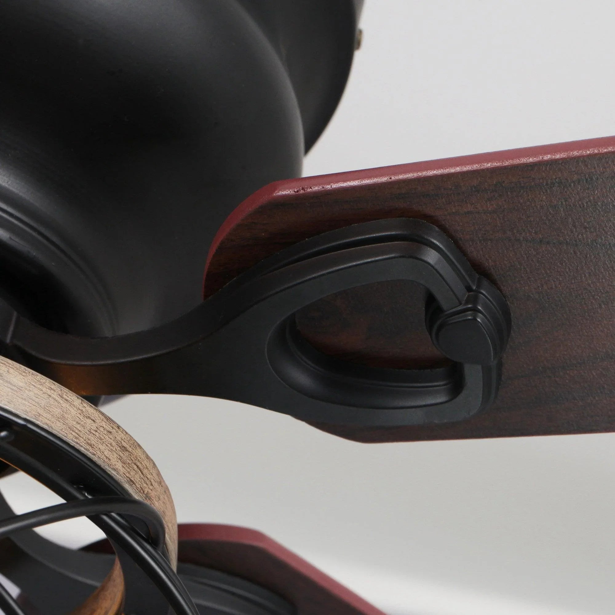 Close-up of blade edge and black flush-mount bracket on a ceiling fan