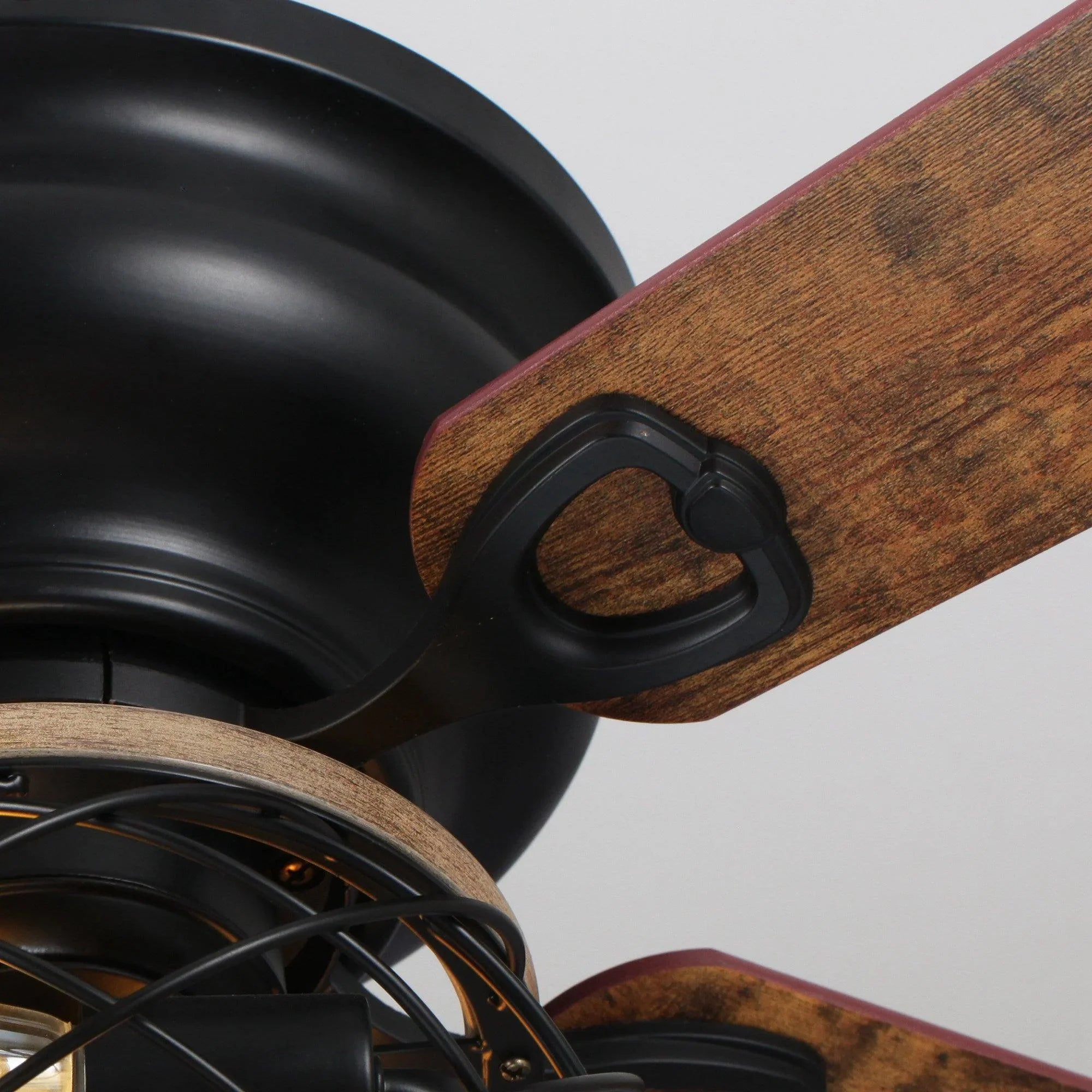 Wooden ceiling fan blade with black flush-mount hub and curved bracket detail