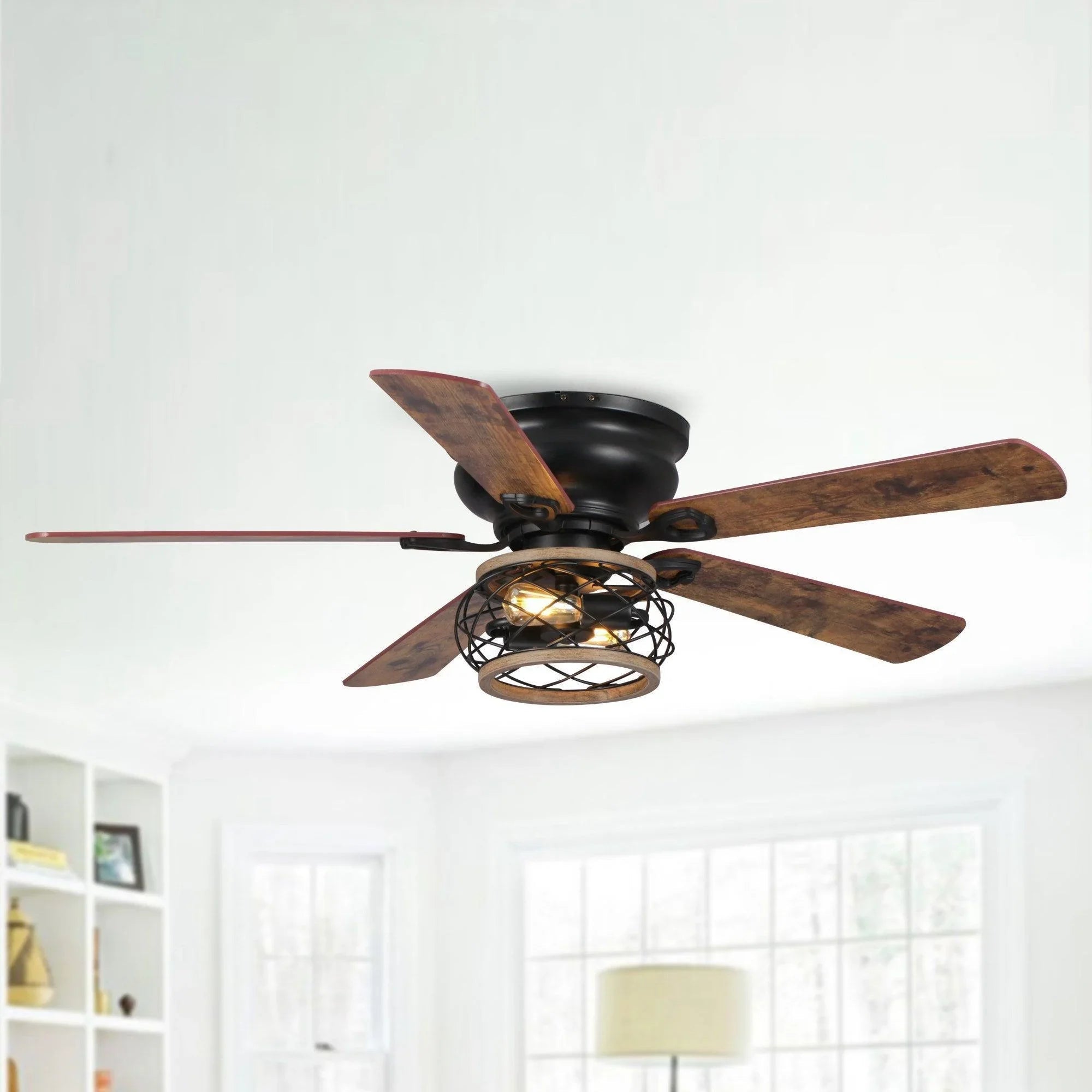 Black flush-mount ceiling fan with dark wood blades and caged light fixture on white ceiling