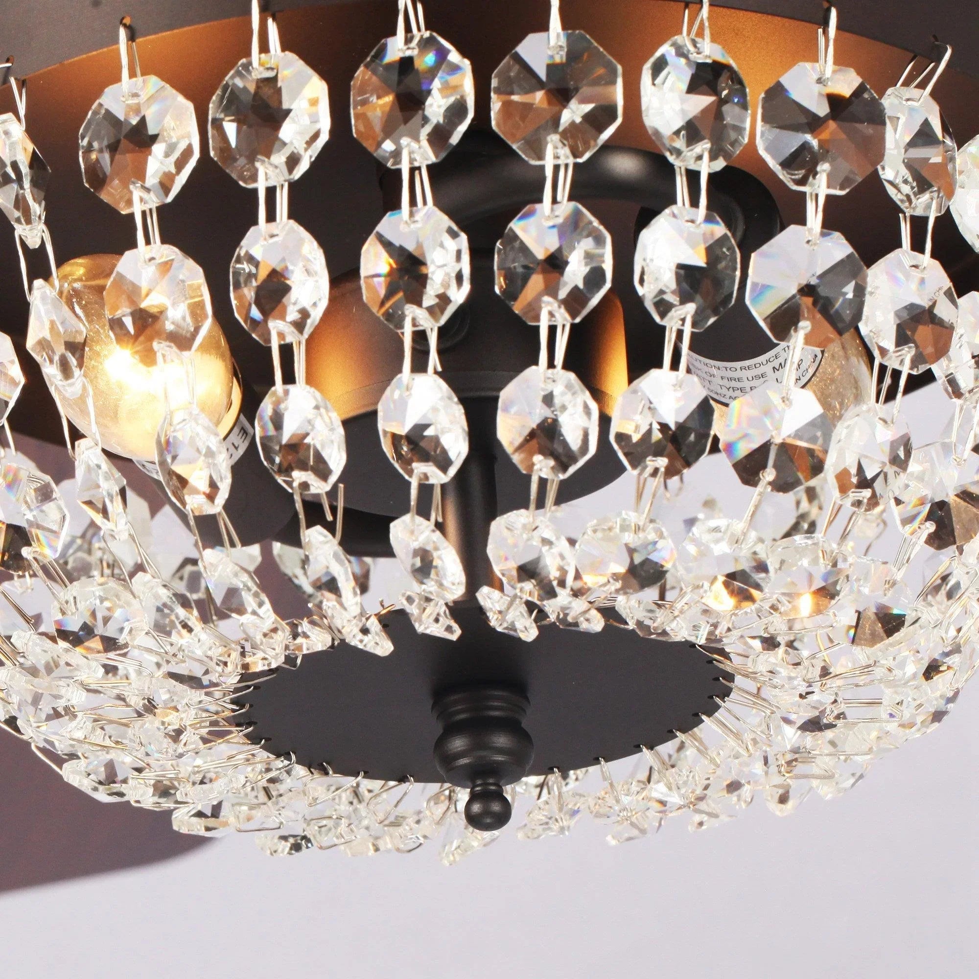 Crystal flush-mount ceiling fan light with many faceted prisms and black motor housing