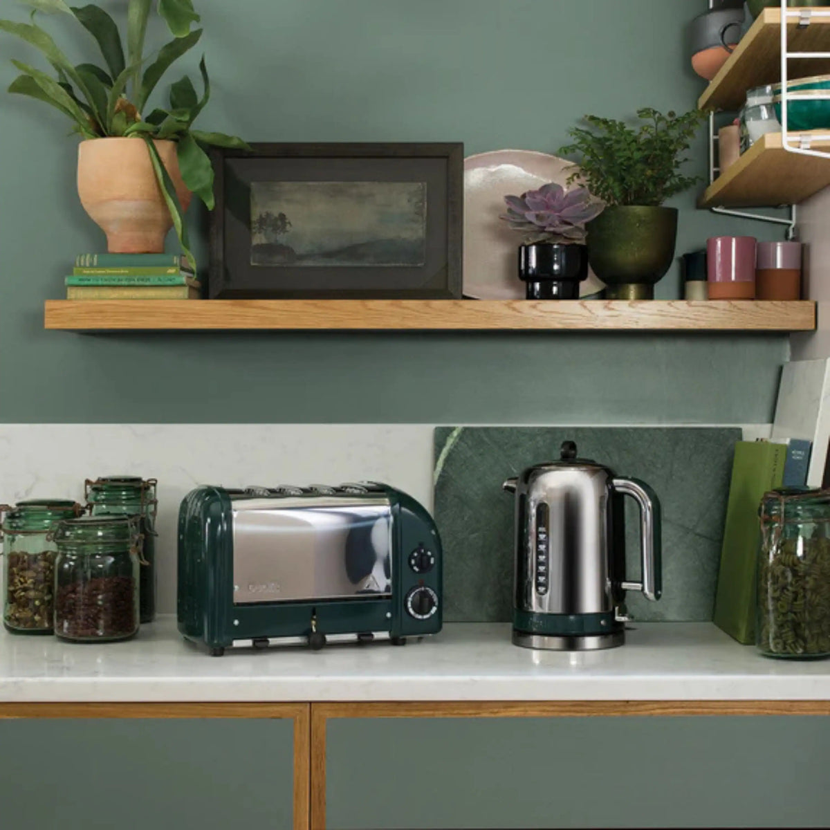 Evergreen Dualit toaster with chrome front panel and round control dials.