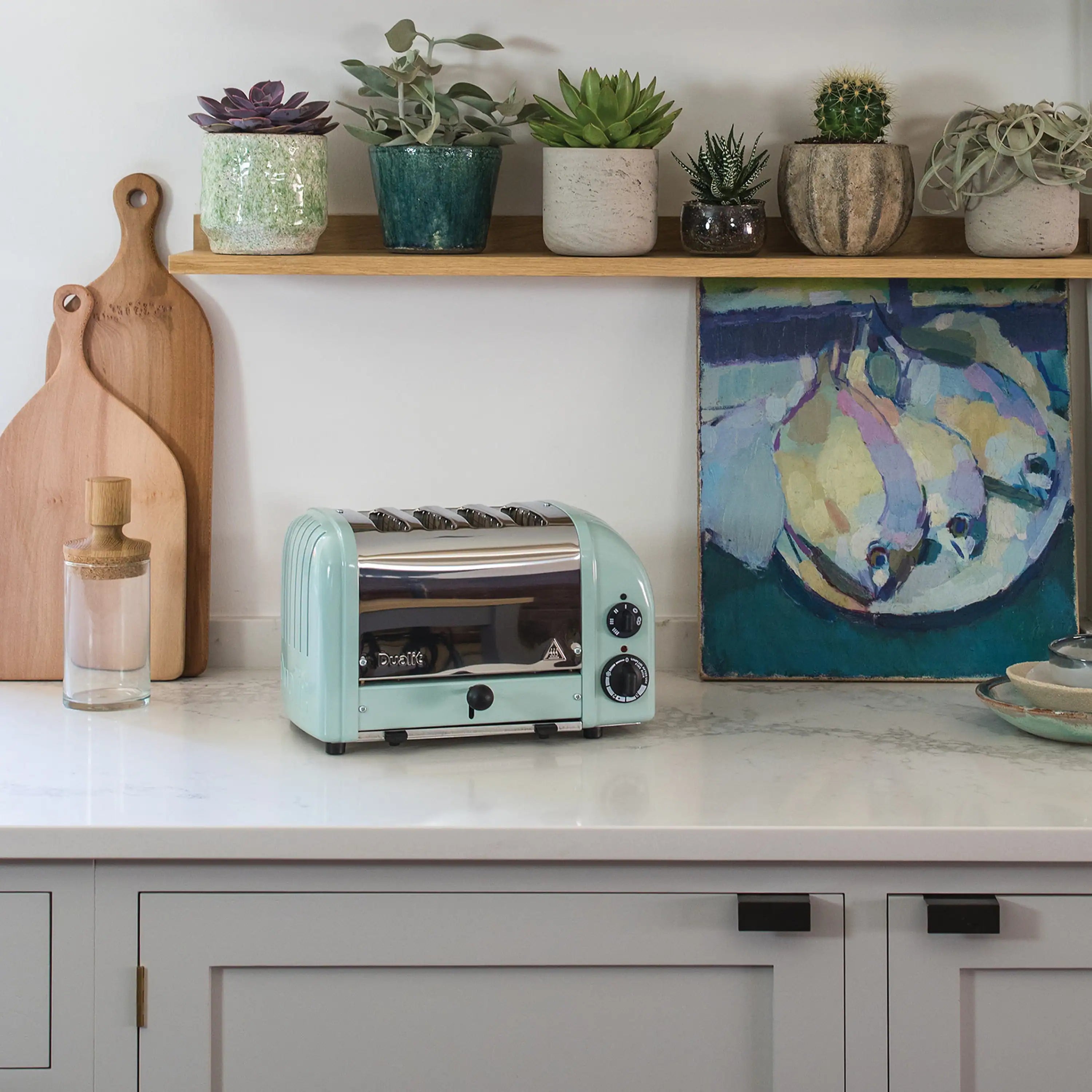 Dualit NewGen four-slice toaster in eucalyptus on a kitchen countertop