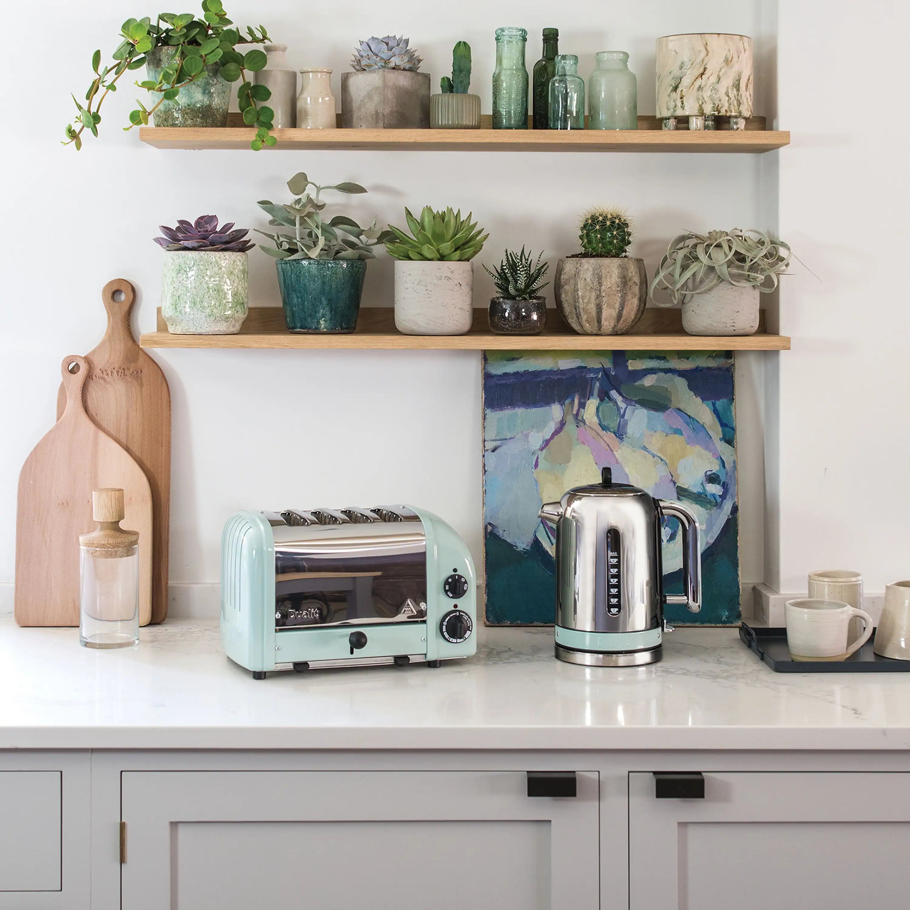 Dualit NewGen four-slice toaster in eucalyptus on countertop near other appliances