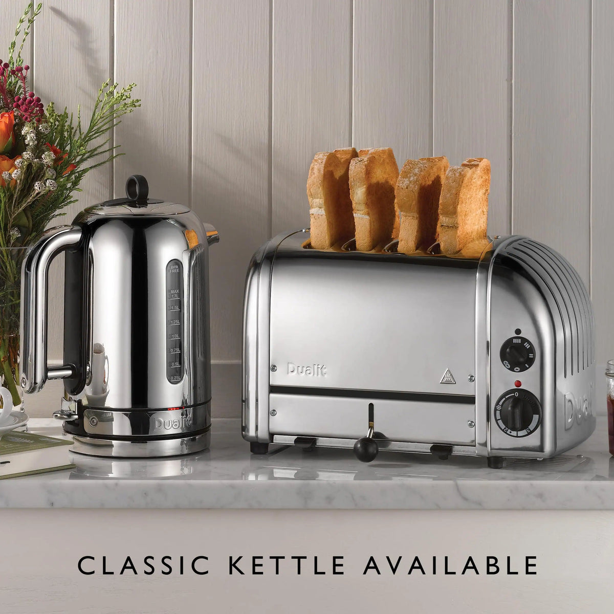 Chrome 4-slice toaster with lever and three toast slices on the slots